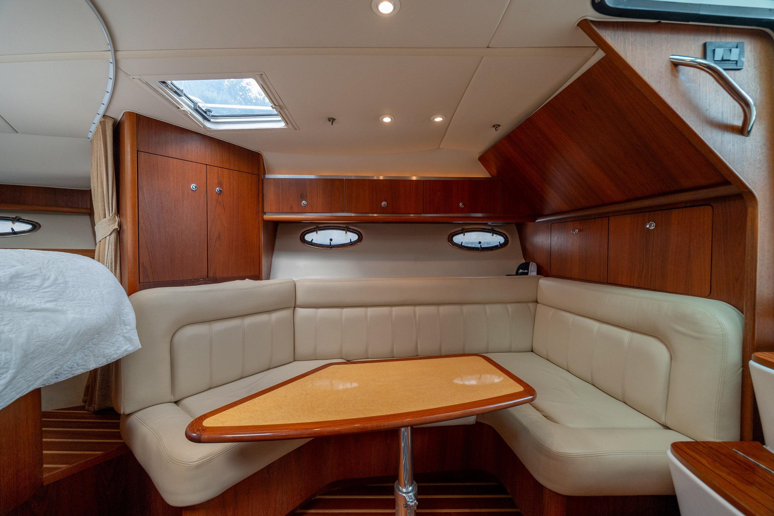 Luxurious interior of 2004 Tiara Yachts 3200 Open with elegant wood and leather seating.