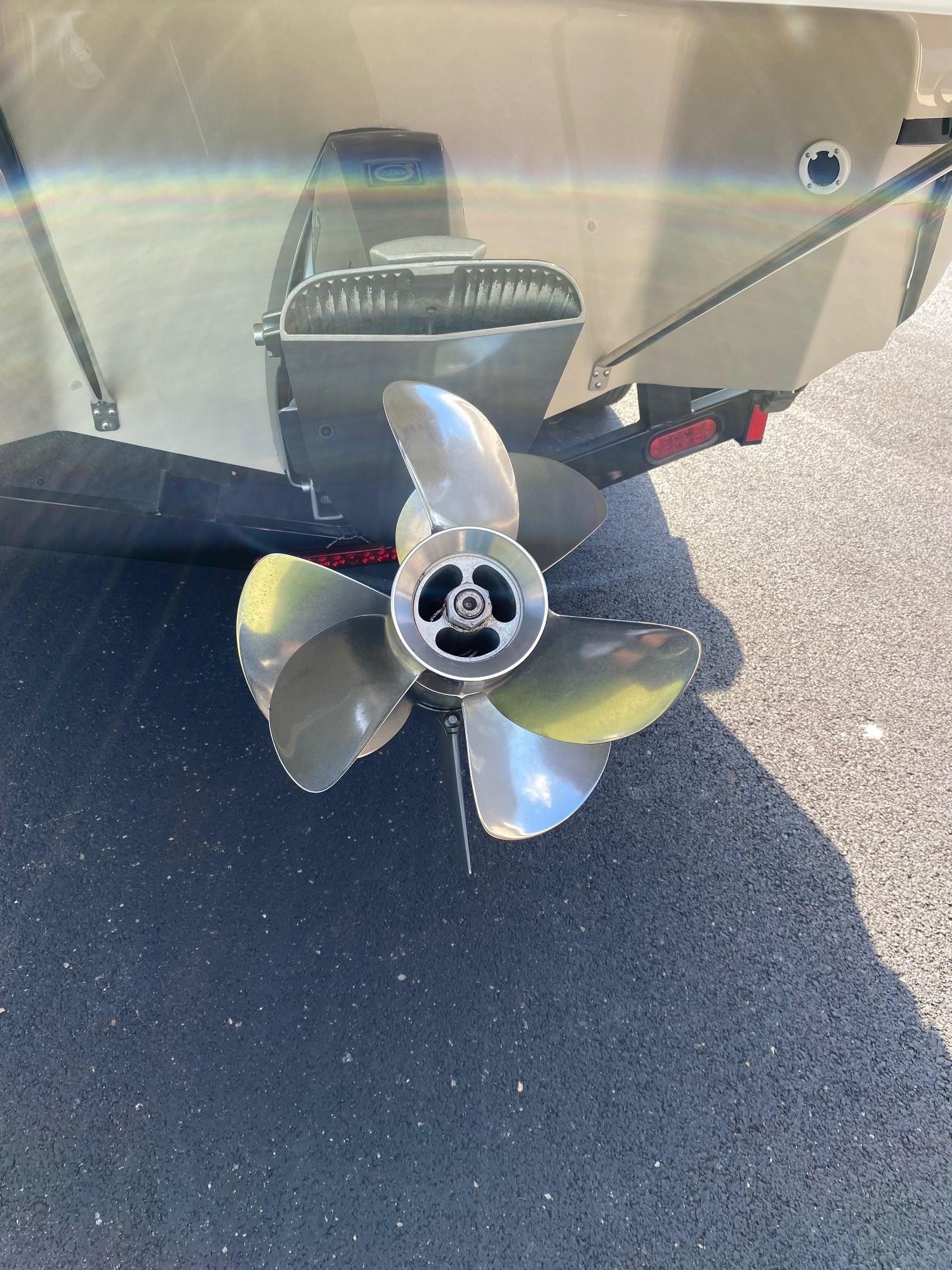 2009 Regal 2400 Bowrider boat propeller on asphalt surface.