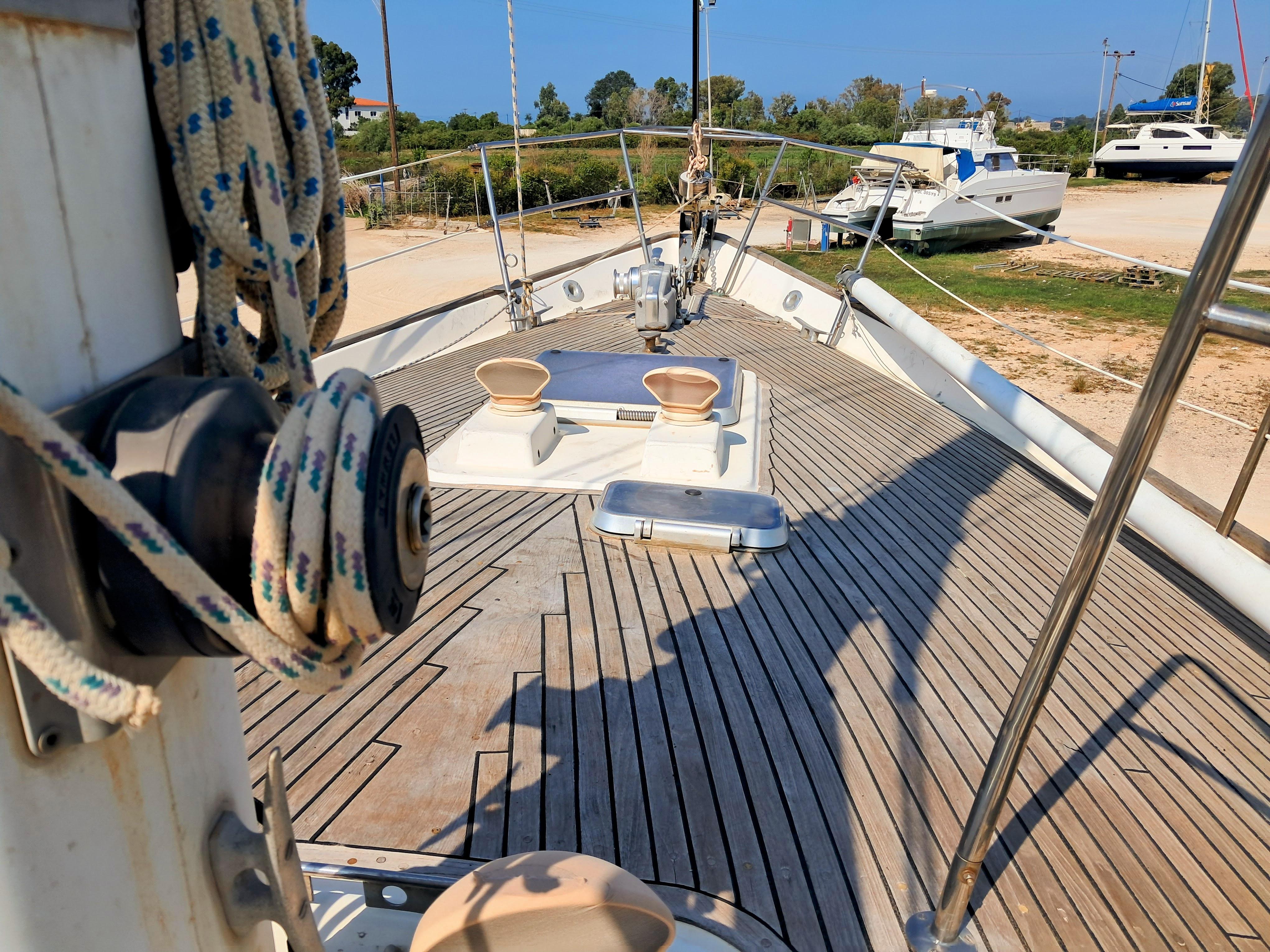 Deck of 1983 Wauquiez Amphitrite sailboat with winch and ropes, docked in a marina.
