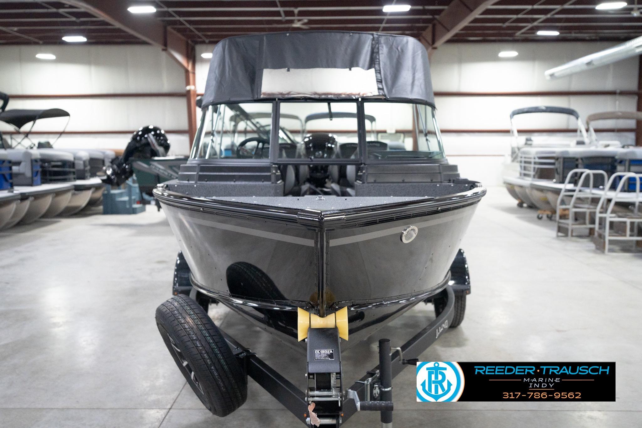 2026 Lund 1800 Explorer Sport boat in showroom, front view, on trailer.