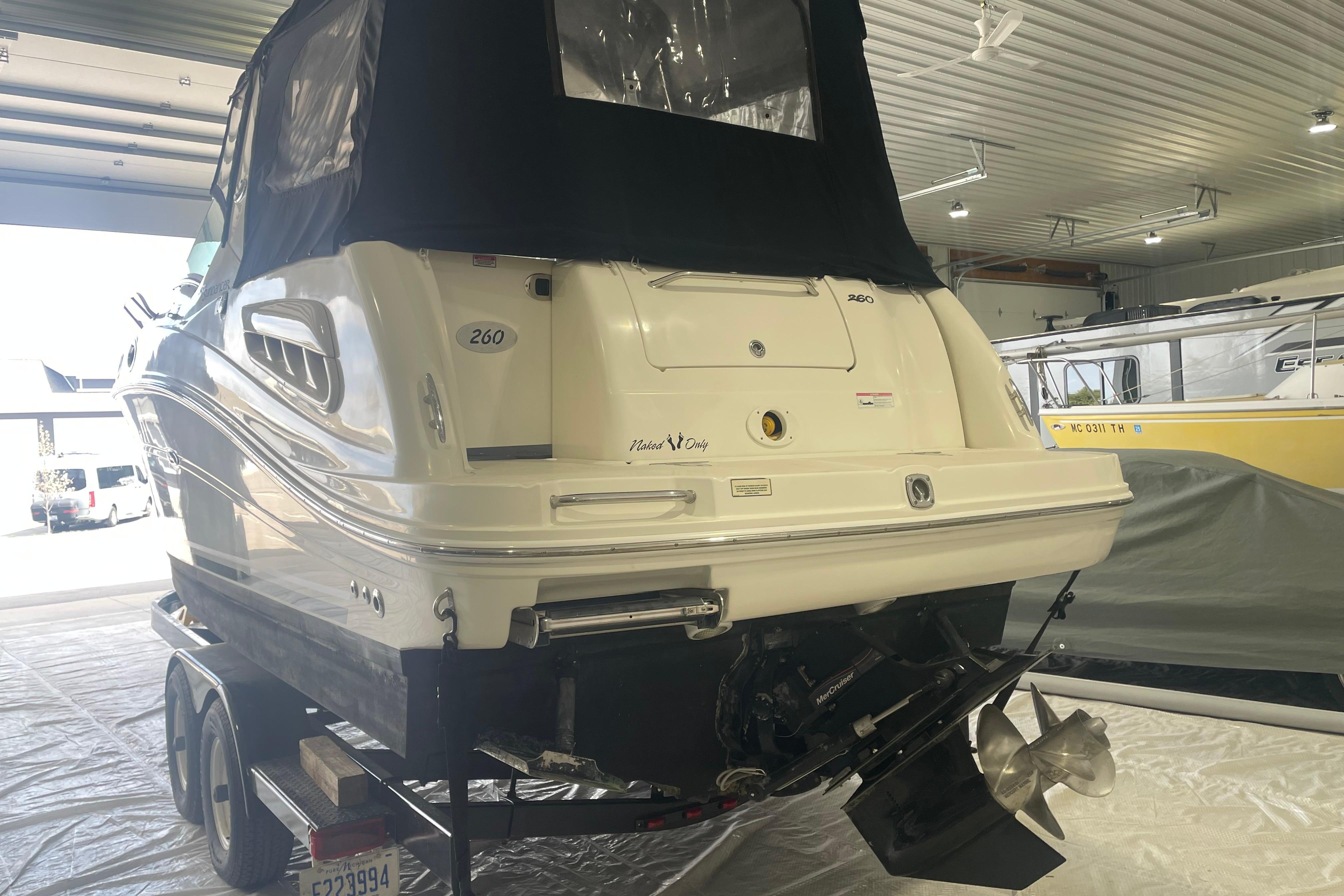 2006 Sea Ray Sundancer 260 boat in indoor storage on a trailer.