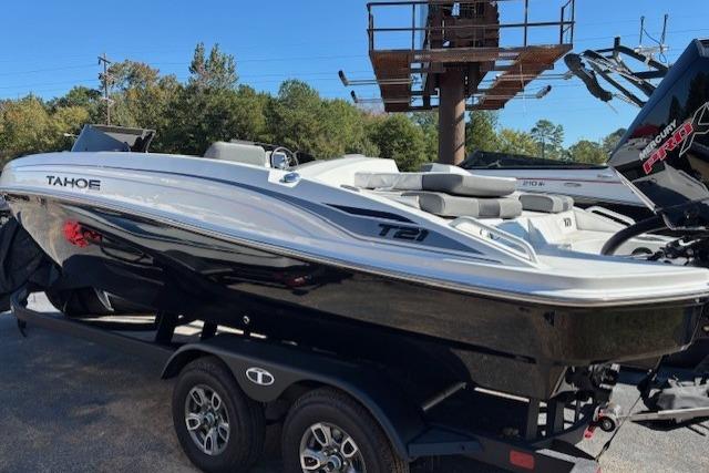 2025 Tahoe T21 boat on trailer, sleek design, parked outdoors.