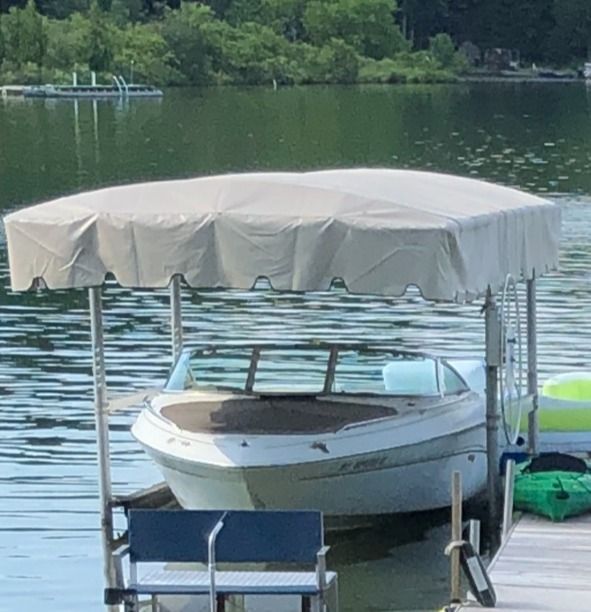 1998 Sea Ray 190 Bow Rider under boat canopy on lake.