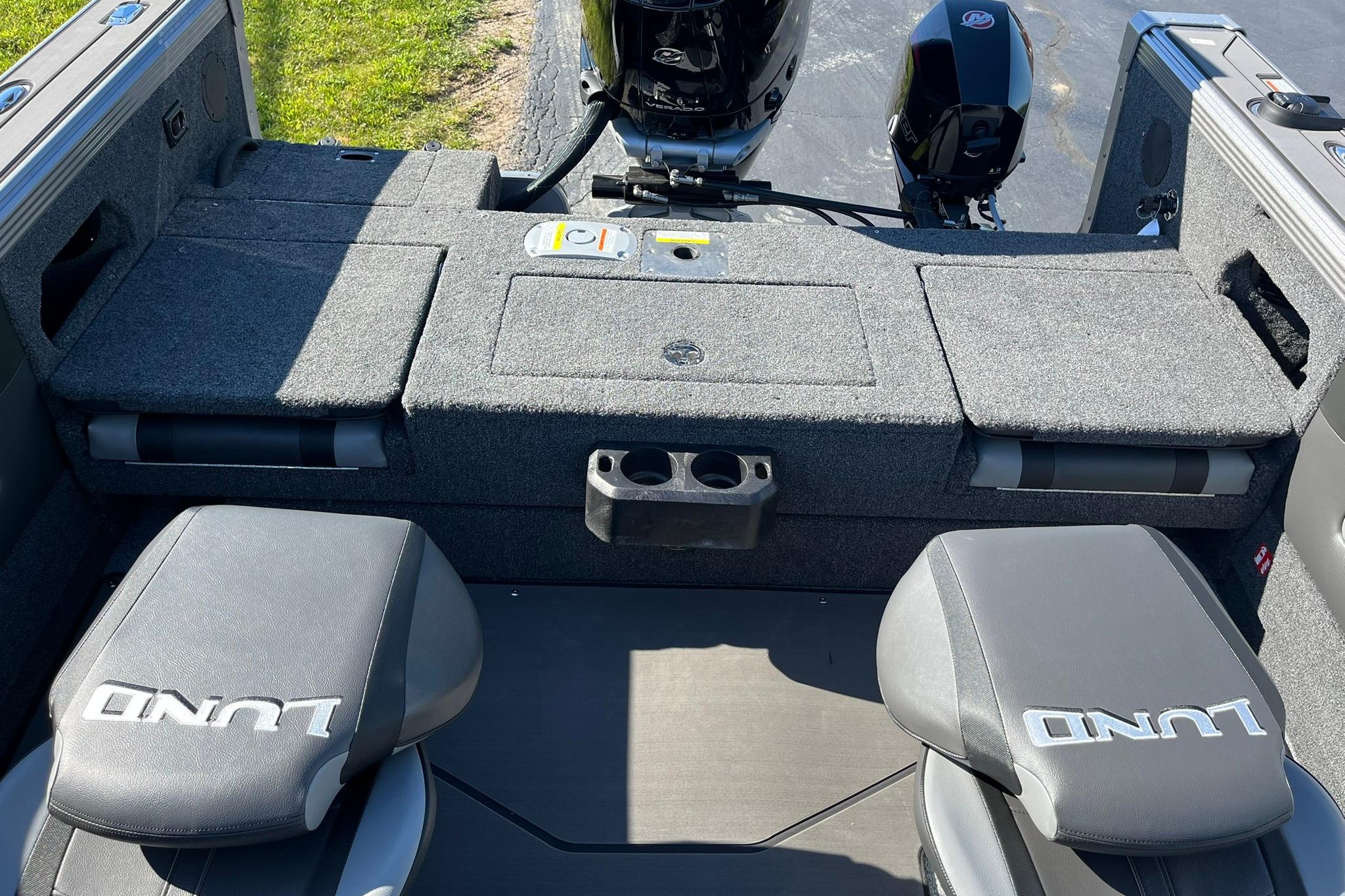 2026 Lund 2275 Baron boat interior with seating and storage compartments.