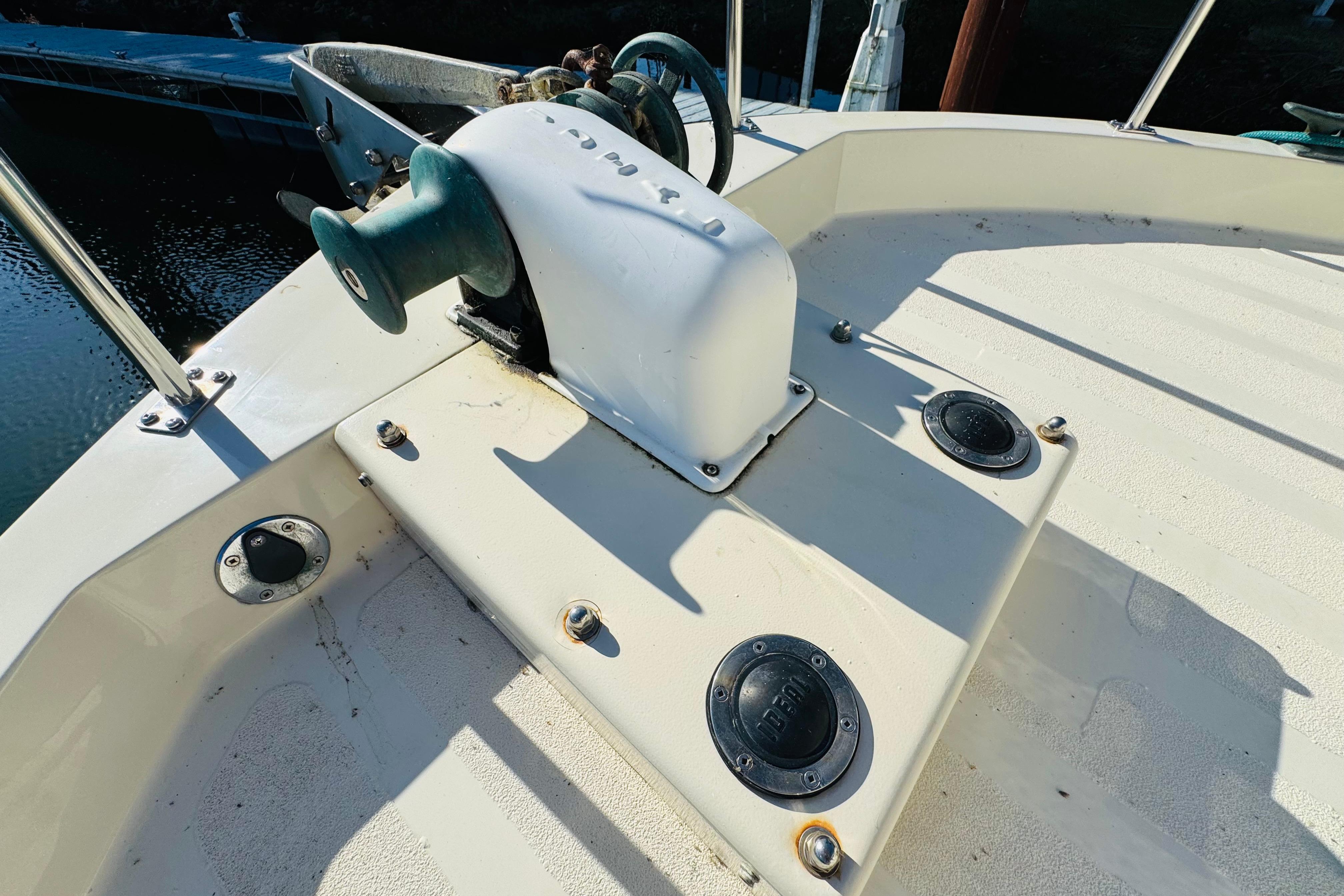 Deck of 1996 Nordic Tug 32 with winch and railing in sunlight.
