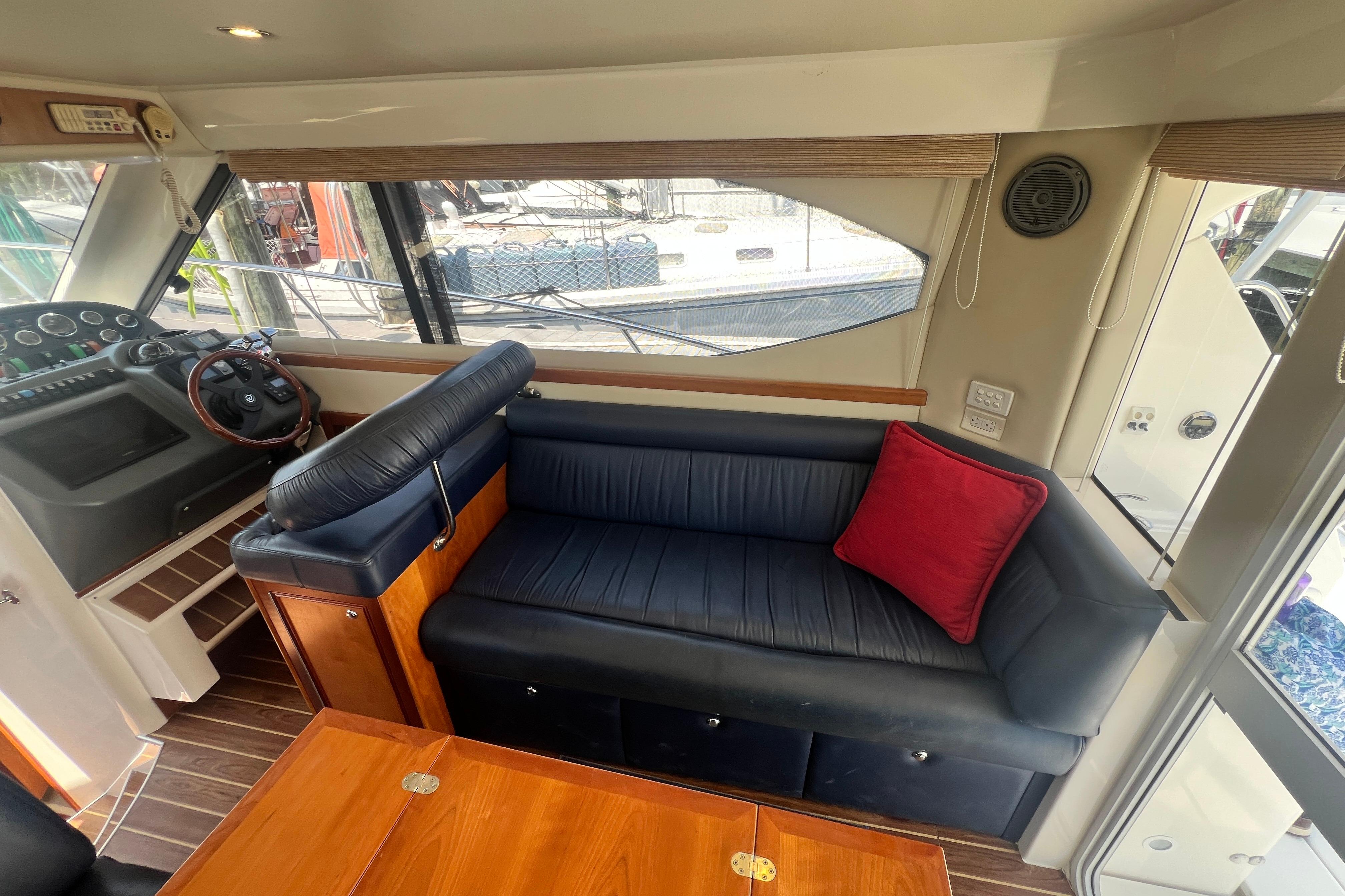 Interior of 2007 Riviera 33 Flybridge yacht with leather seating and wooden accents.