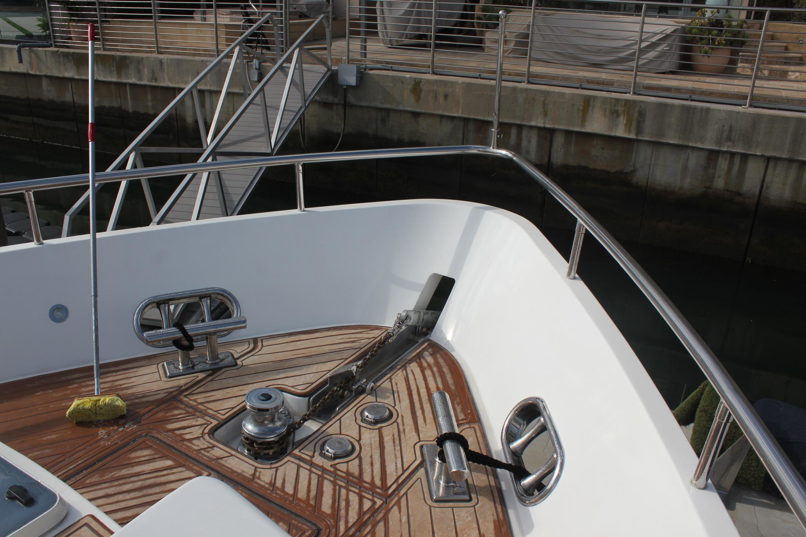 Bow deck of 1999 Horizon 70 Motor Yacht with anchor and railing.