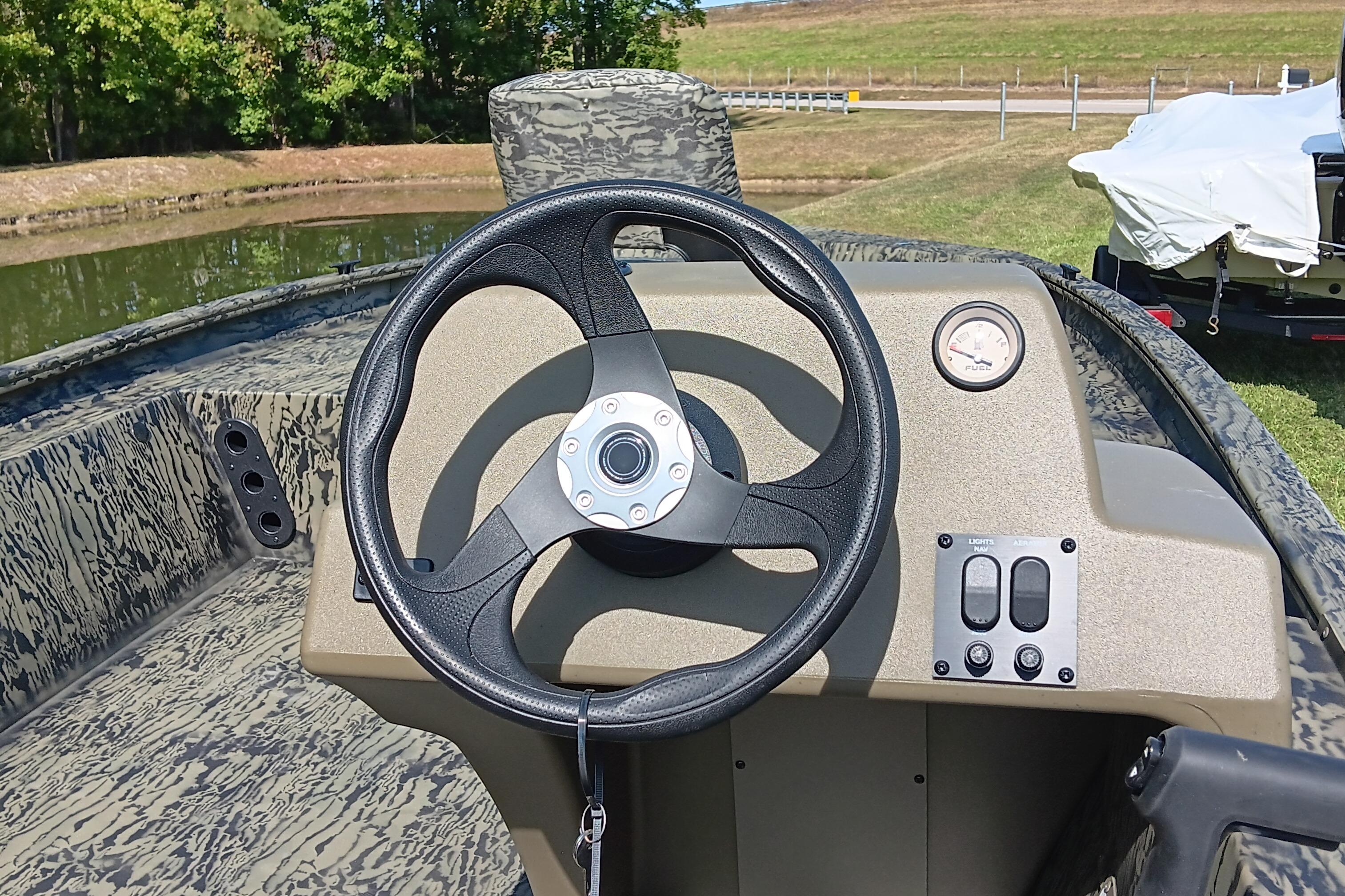 2026 Tracker Grizzly 1754 SC boat dashboard with steering wheel and controls.