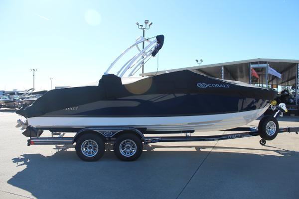 2025 Cobalt CS23 boat on trailer, covered and parked outdoors.