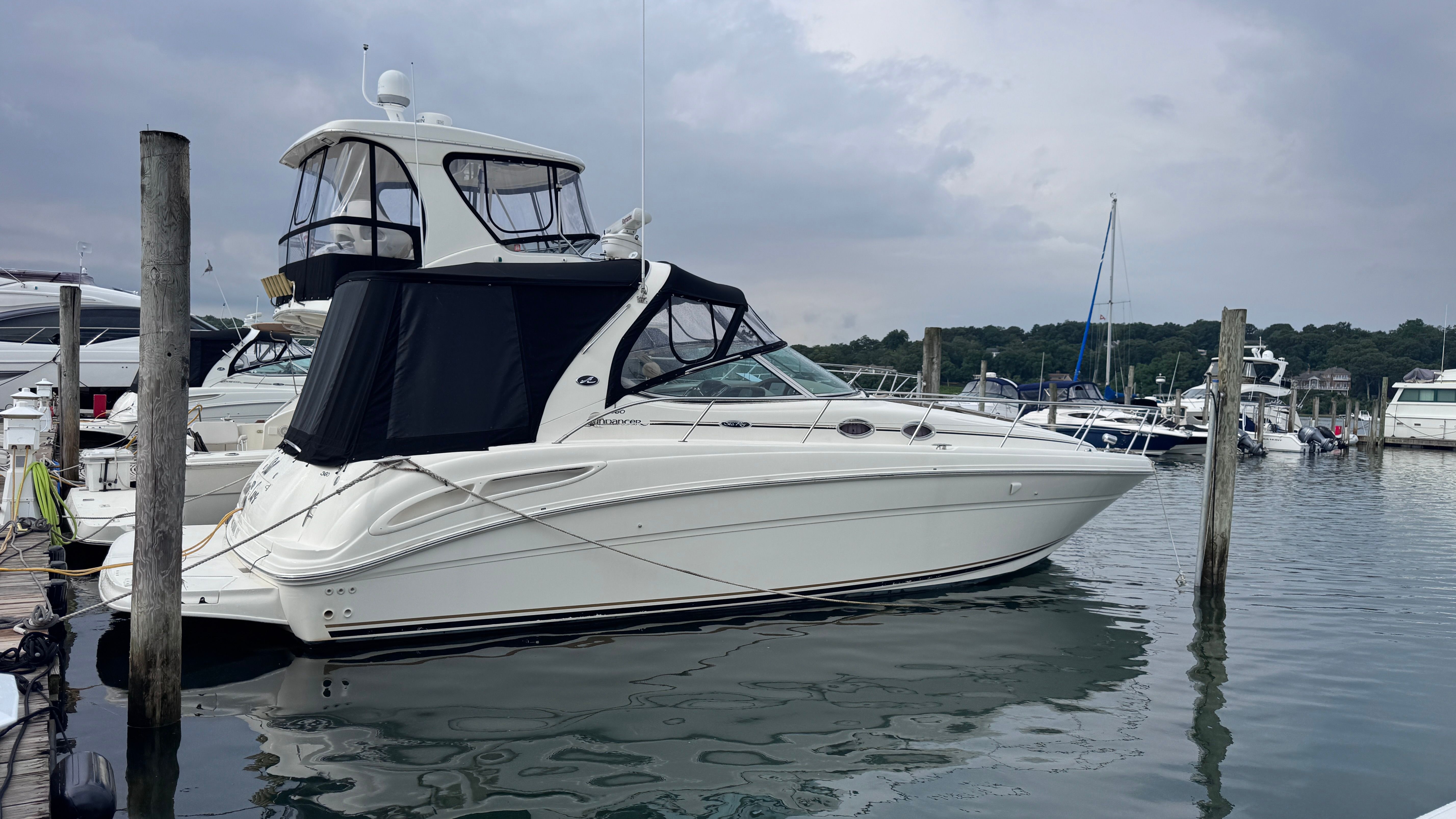 A 2003 Sea Ray 360 Sundancer is docked on the water.