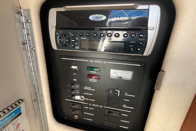 Control panel of a 2003 Sea Ray 260 Sundancer boat with Clarion audio system.