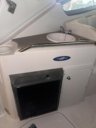 2005 Four Winns 298 Vista boat interior with sink and storage cabinet.