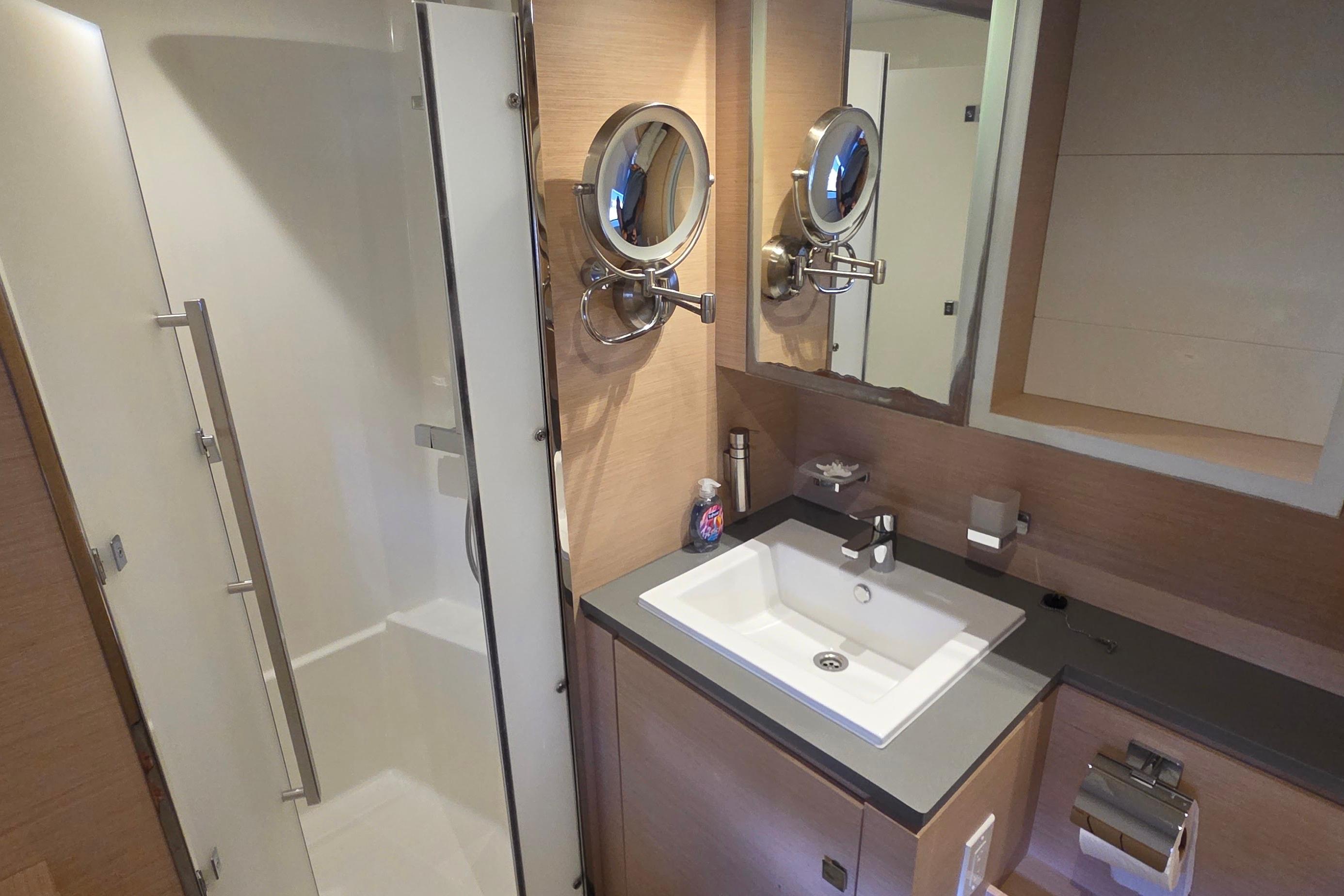 Modern bathroom on 2018 Fountaine Pajot Motor Yacht 44 with sleek fixtures and shower.