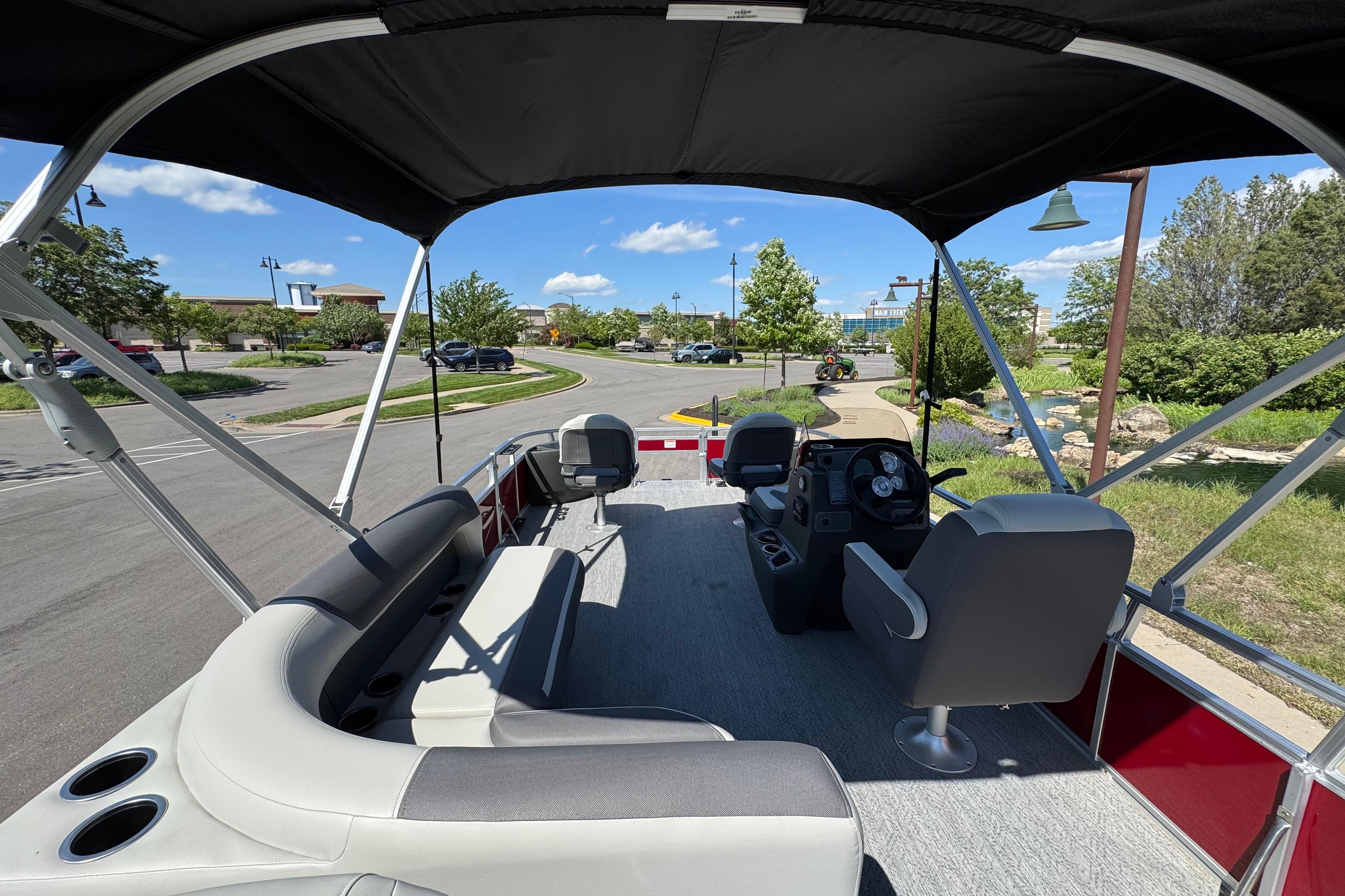 2026 Sun Tracker Bass Buggy 18 DLX pontoon boat interior with seating and steering console.