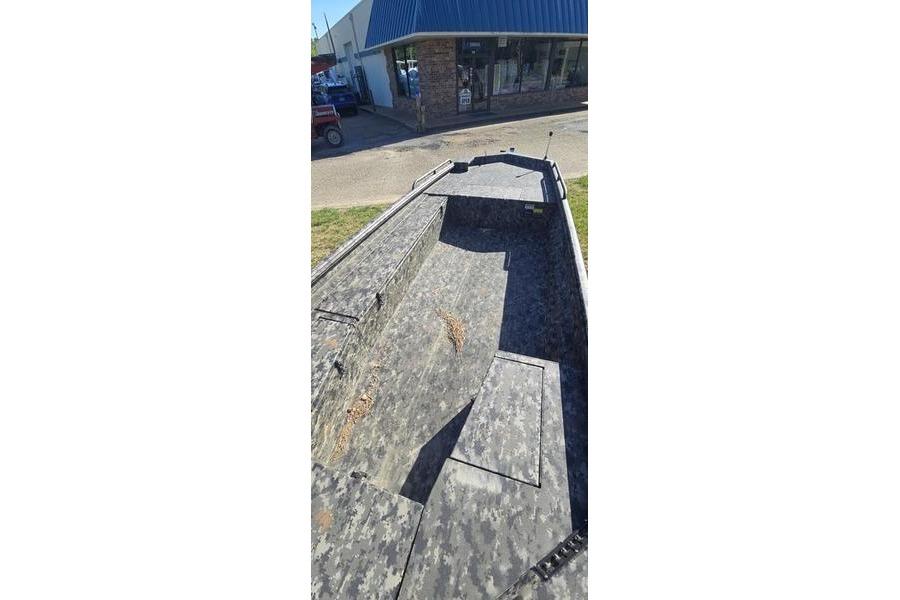 2026 Havoc 1860 DBST boat with camouflage interior, parked outside a building.
