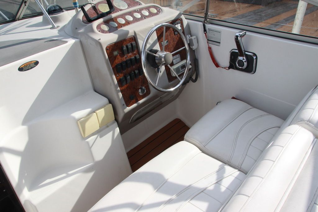Interior of 1999 Maxum 2400 Mercruiser with steering wheel and seats.