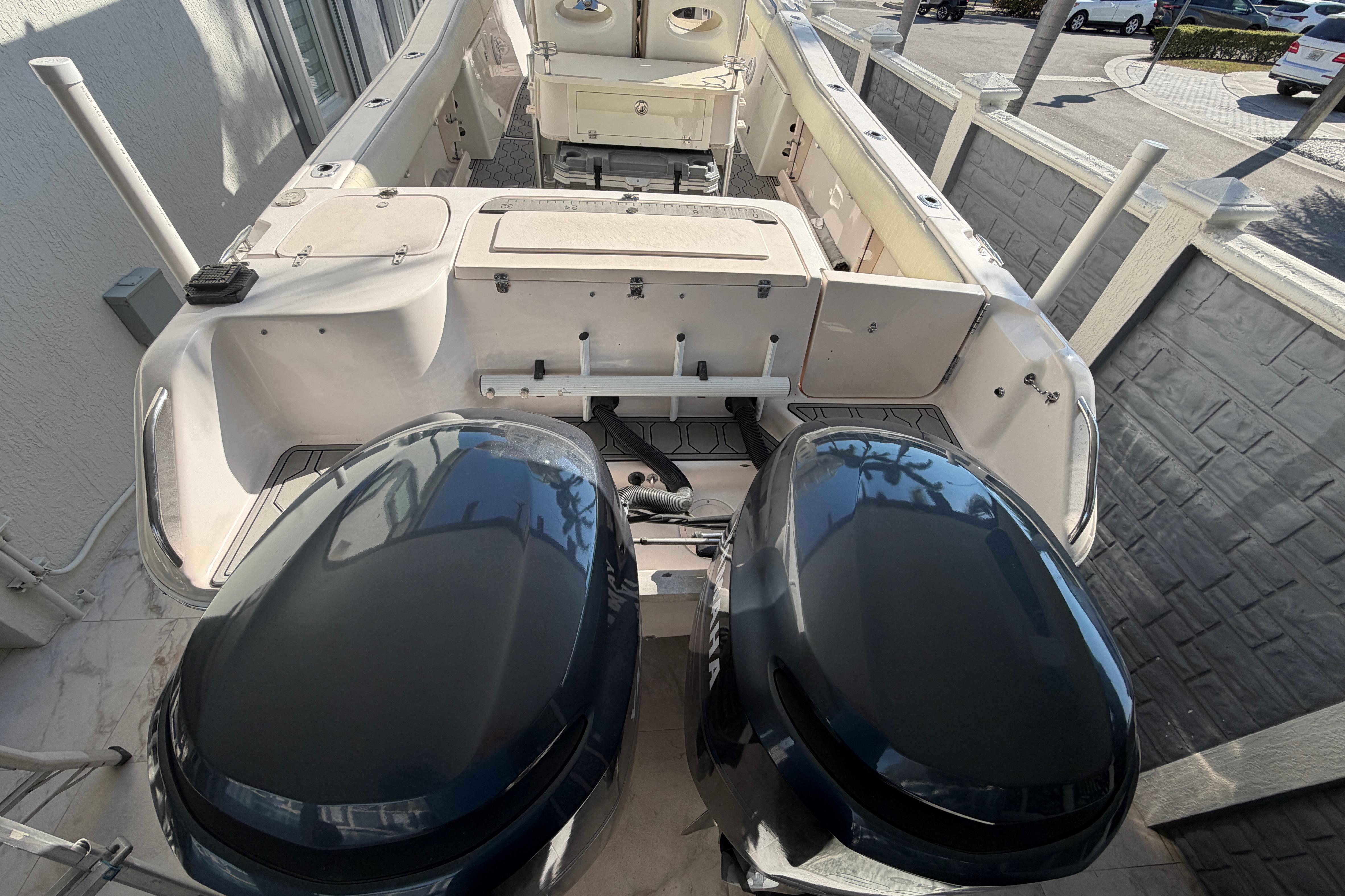 2004 Grady White 273 boat with dual outboard engines, docked in a marina.