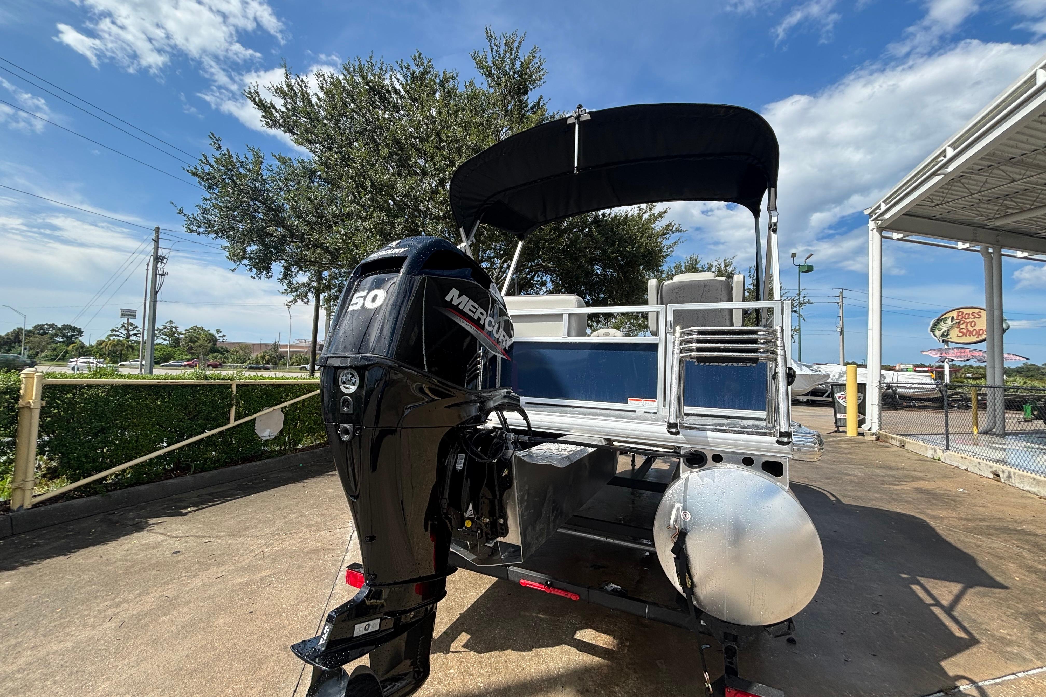 2026 Sun Tracker Bass Buggy 16 XL Select with Mercury 50 engine, parked outdoors.