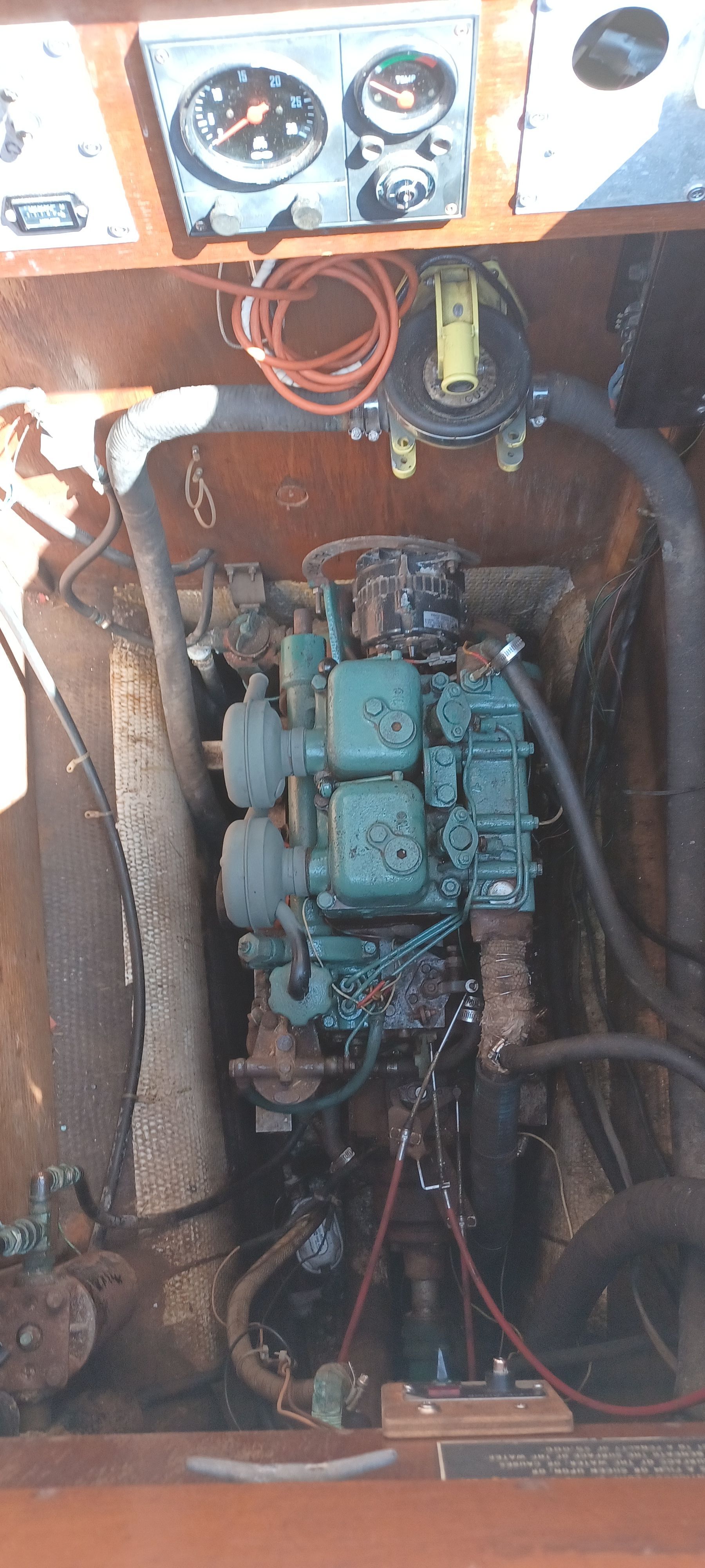 A boat engine with green components and a dashboard.