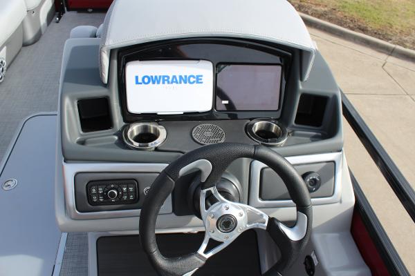2025 Regency 230 DL3 boat dashboard with Lowrance display and steering wheel.