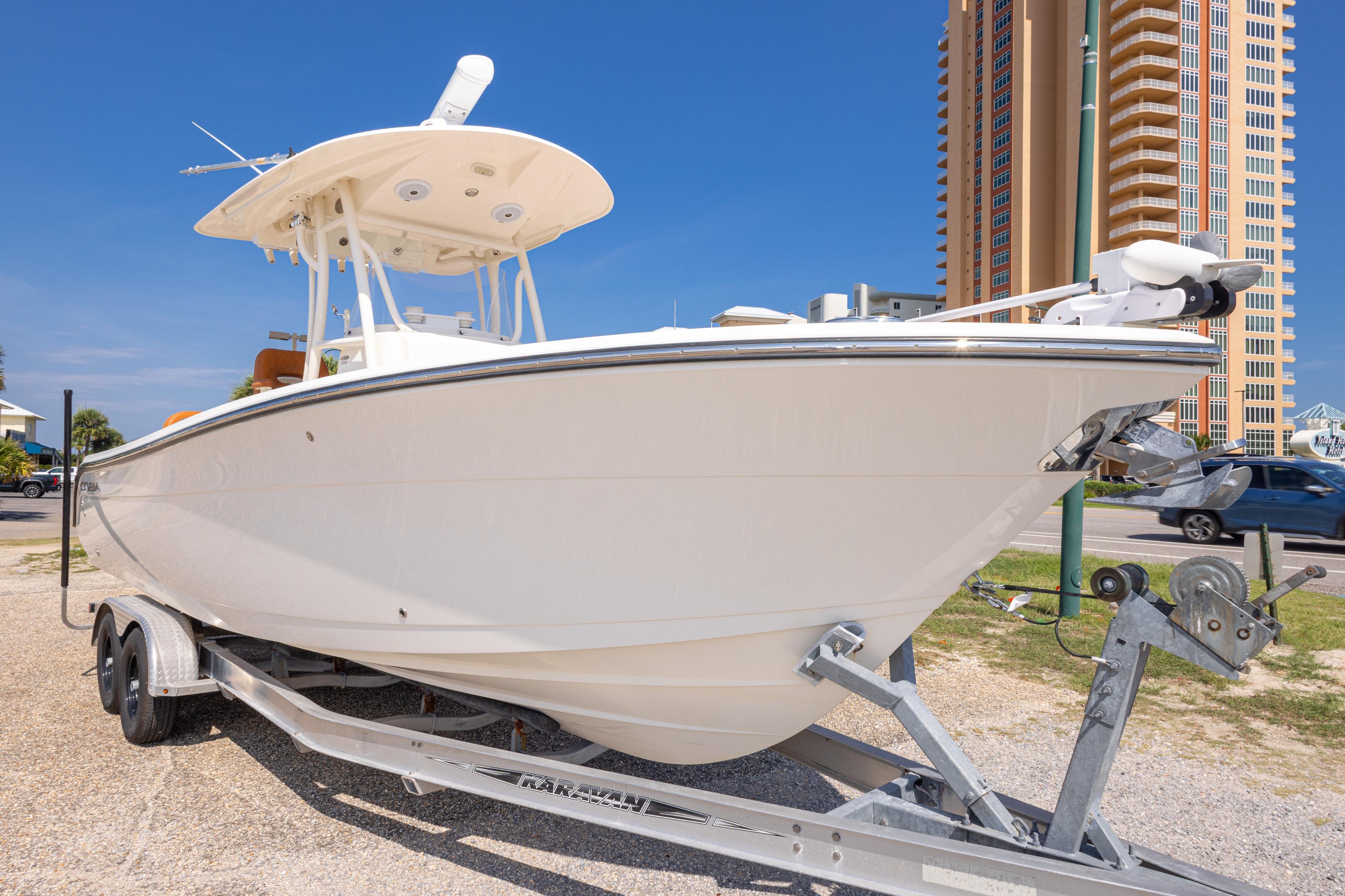2017 Cobia 261 Center Console boat on trailer, urban backdrop, clear sky.
