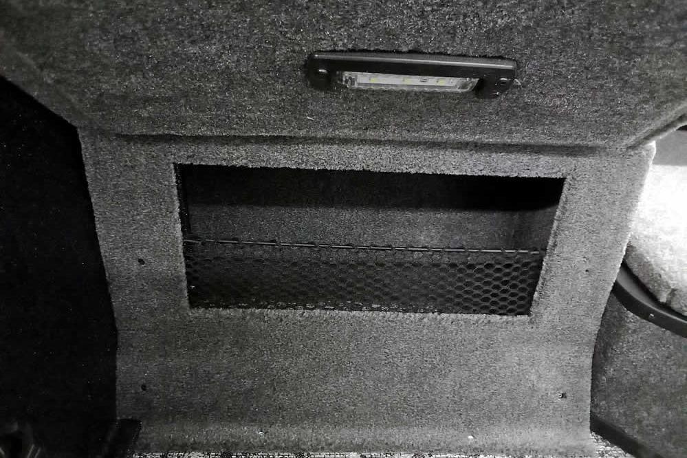 Interior storage compartment of 2026 Ranger VX1888 WT with netting and light.