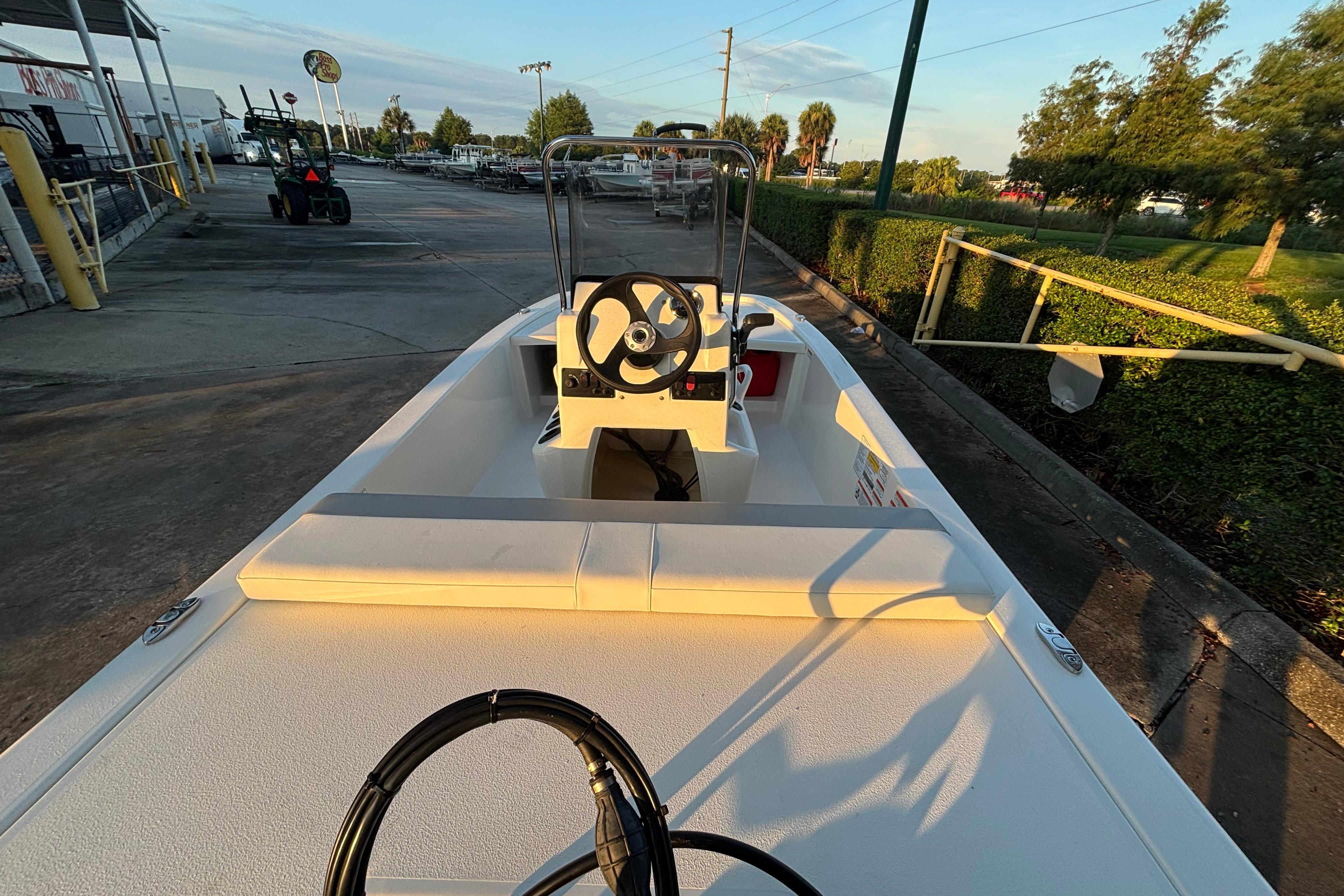 2026 Mako Pro Skiff 13 CC boat, docked, with steering console and open deck.