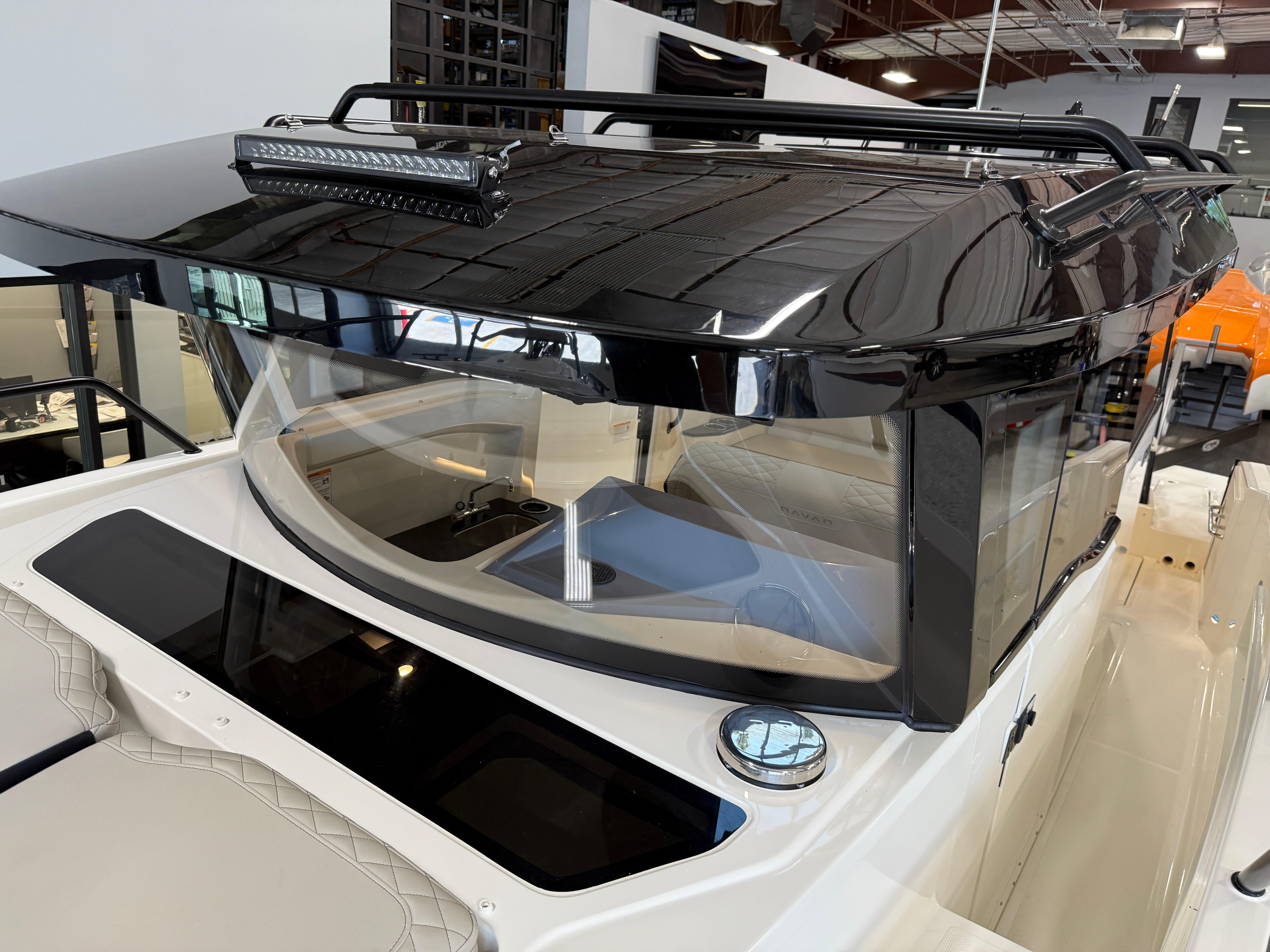 Navan C30 2025 boat with sleek black roof and modern design in showroom.