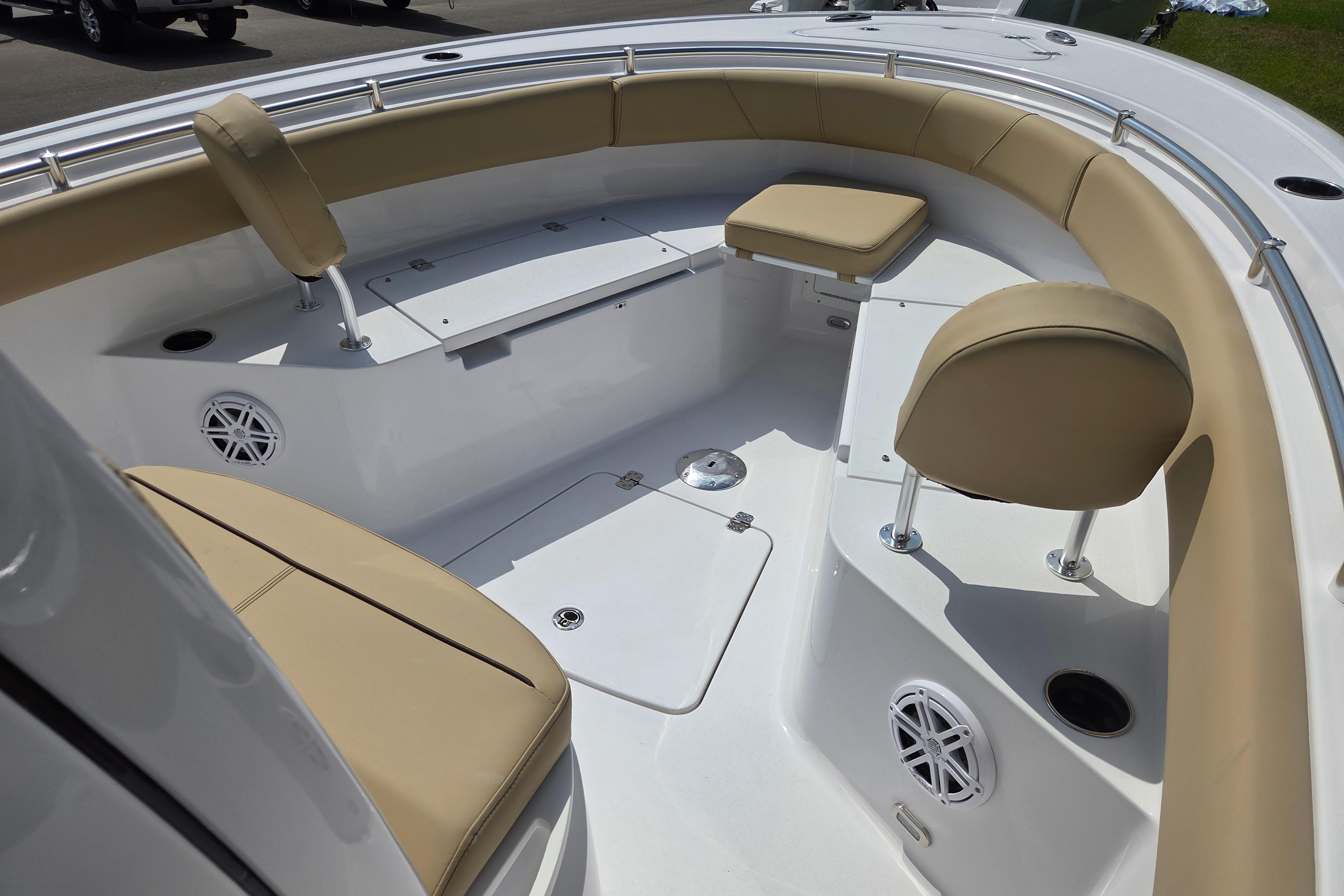 2026 Sportsman Open 232 Center Console boat interior with beige seating and white deck.