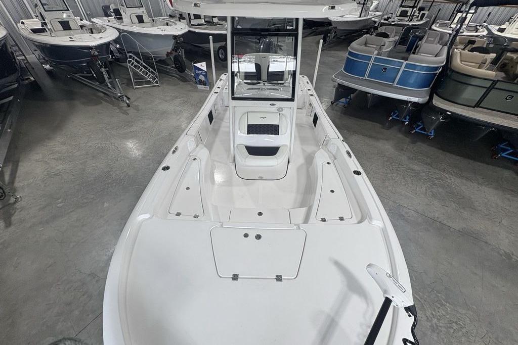 2026 Tidewater 2210 Carolina Bay boat in showroom, surrounded by other boats.