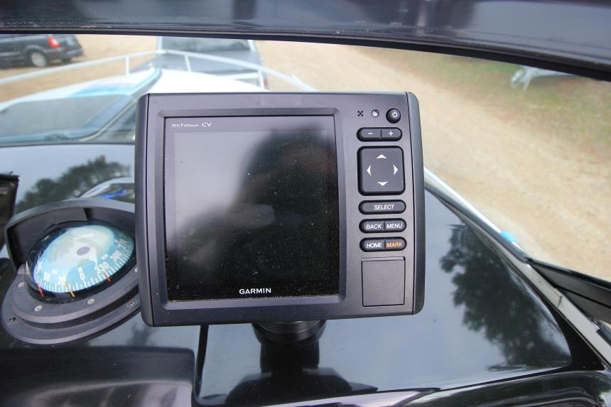 Garmin navigation system and compass on 1989 Formula 223 SS boat dashboard.