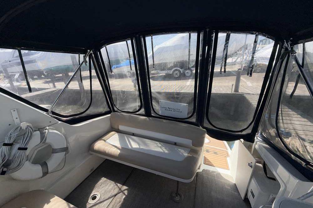 Interior view of a 2001 Monterey 282 Cruiser boat with seating and windows.