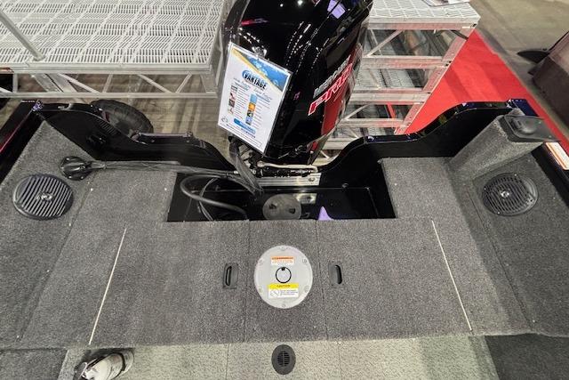 2026 Crestliner 1850 Kodiak WT boat interior with motor and carpeted deck.