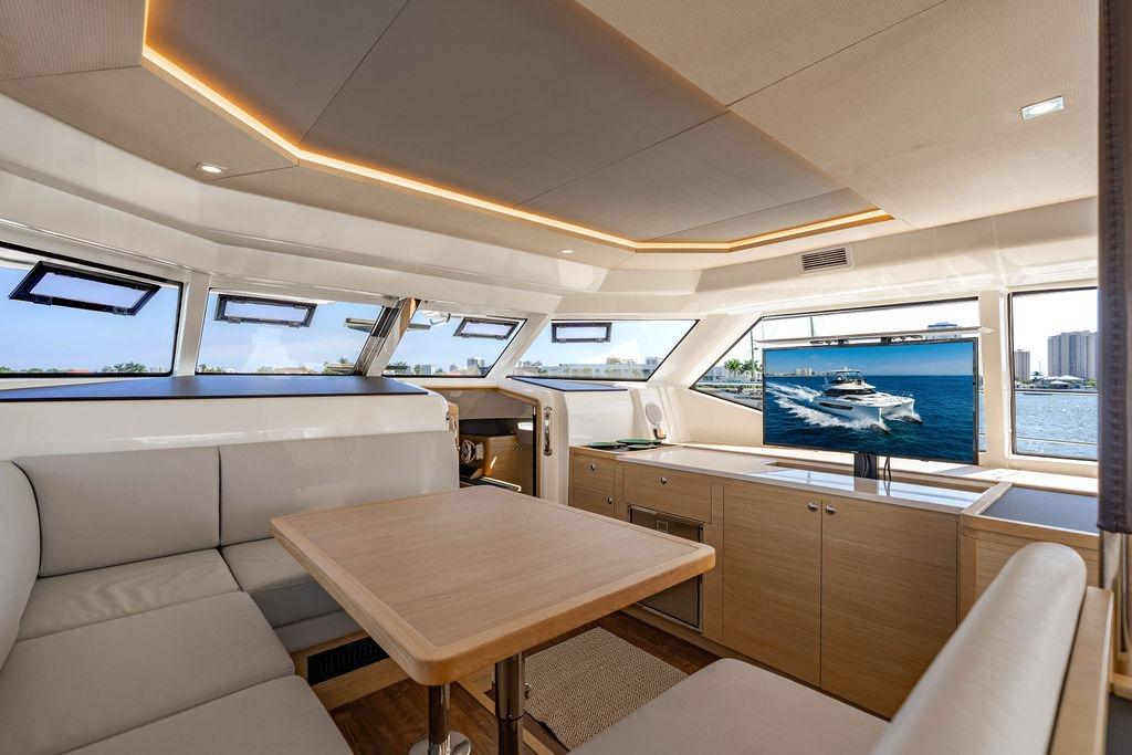 Luxurious interior of 2024 Aquila 44 Yacht with modern seating and panoramic windows.