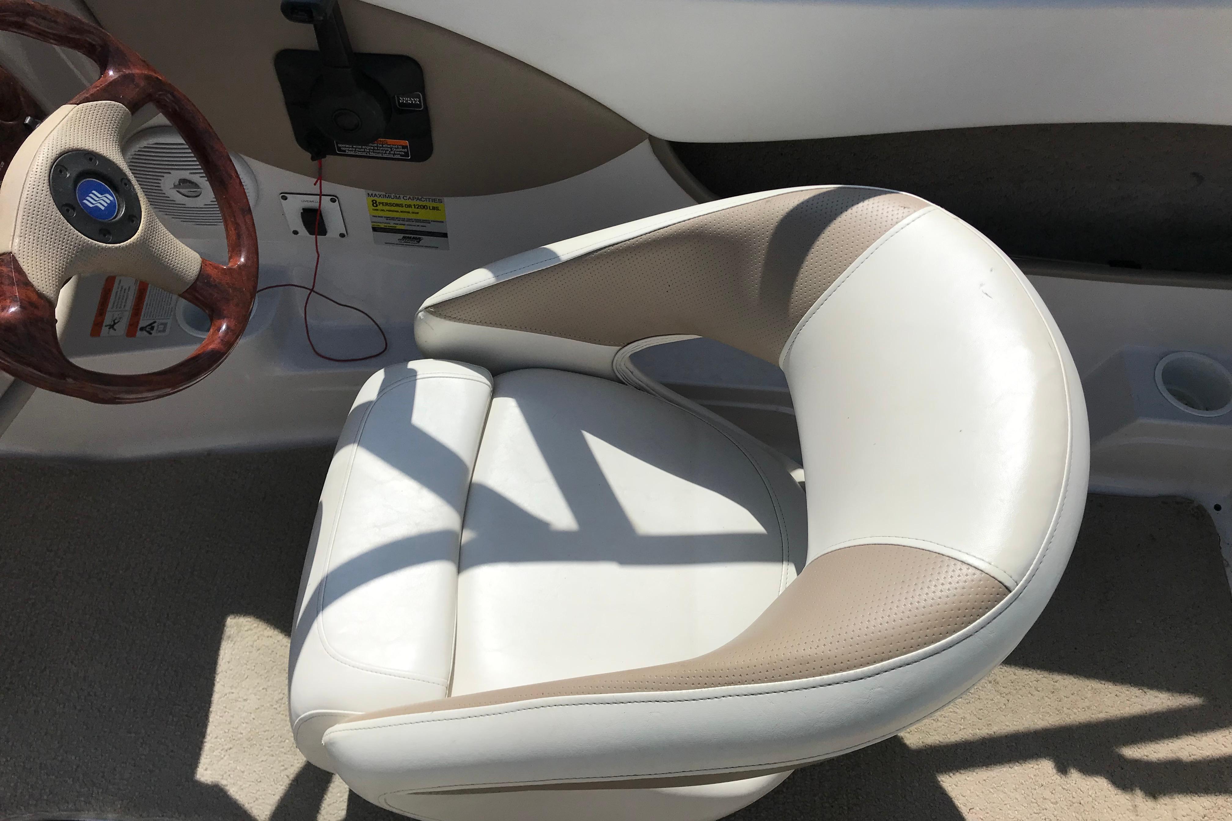 2005 Four Winns 180 Horizon FS boat interior with steering wheel and cushioned seat.