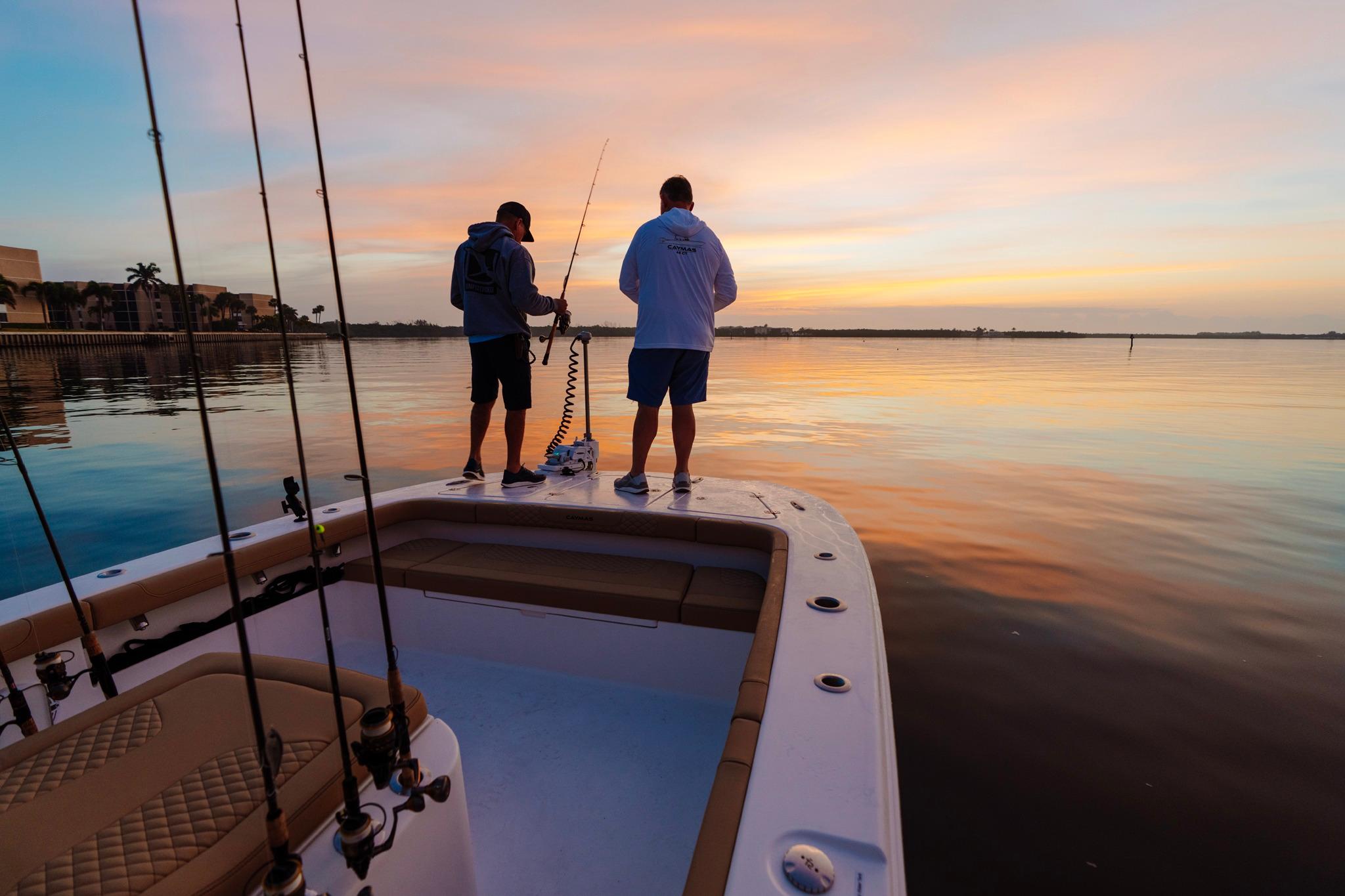 Two anglers on a Caymas 29 CT boat at sunset.