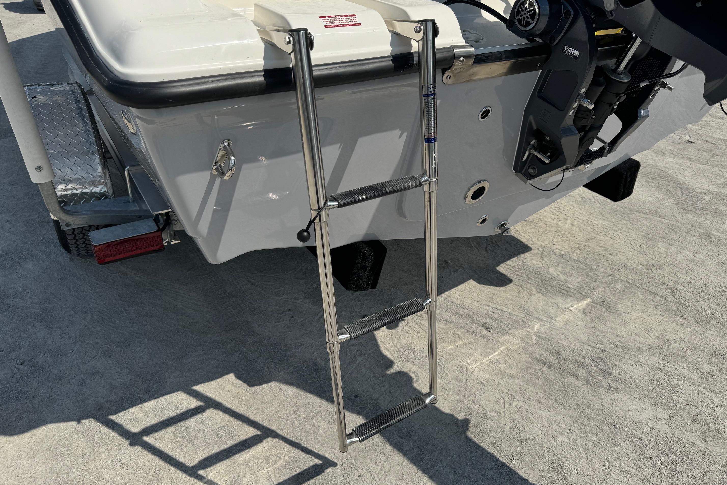 2025 Key West 203 FS boat with a stainless steel boarding ladder.