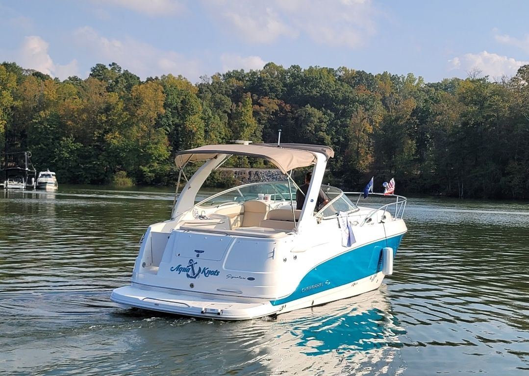 2006 Chaparral Signature 280 boat on a serene lake.