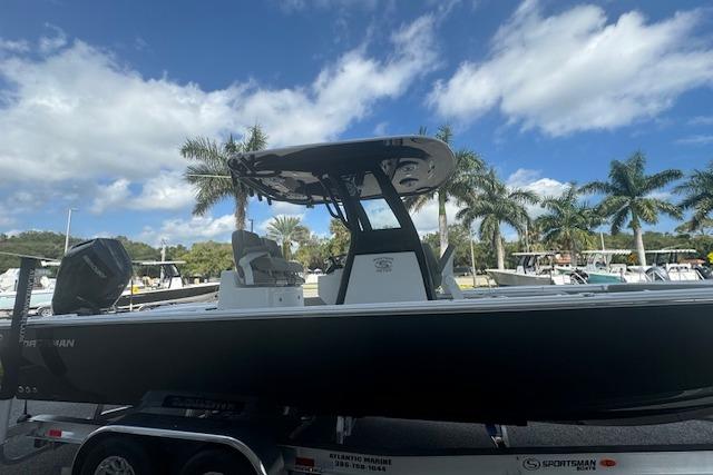 2025 Sportsman Masters 267OE Bay Boat on trailer, palm trees in background.