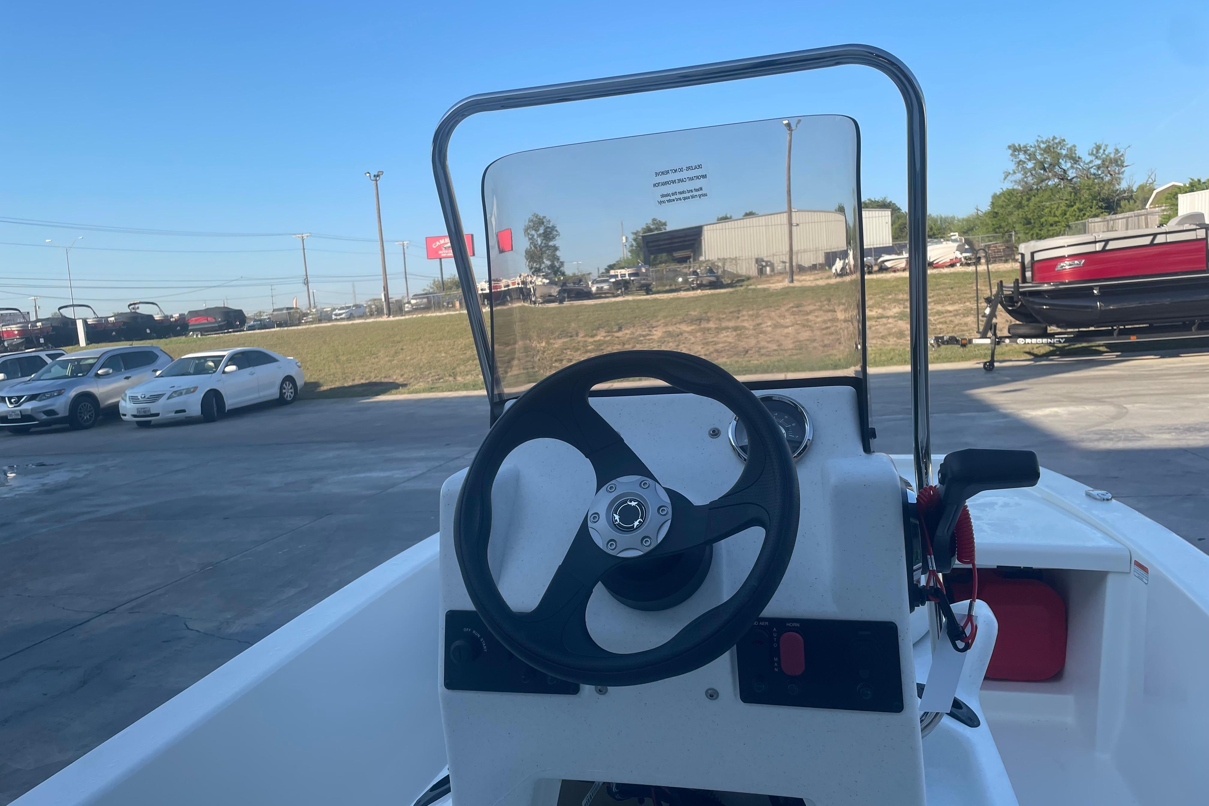 2026 Mako Pro Skiff 13 CC boat steering console in a parking lot.