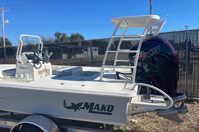 2026 Mako 18 Pro Skiff boat with ladder and powerful outboard motor.
