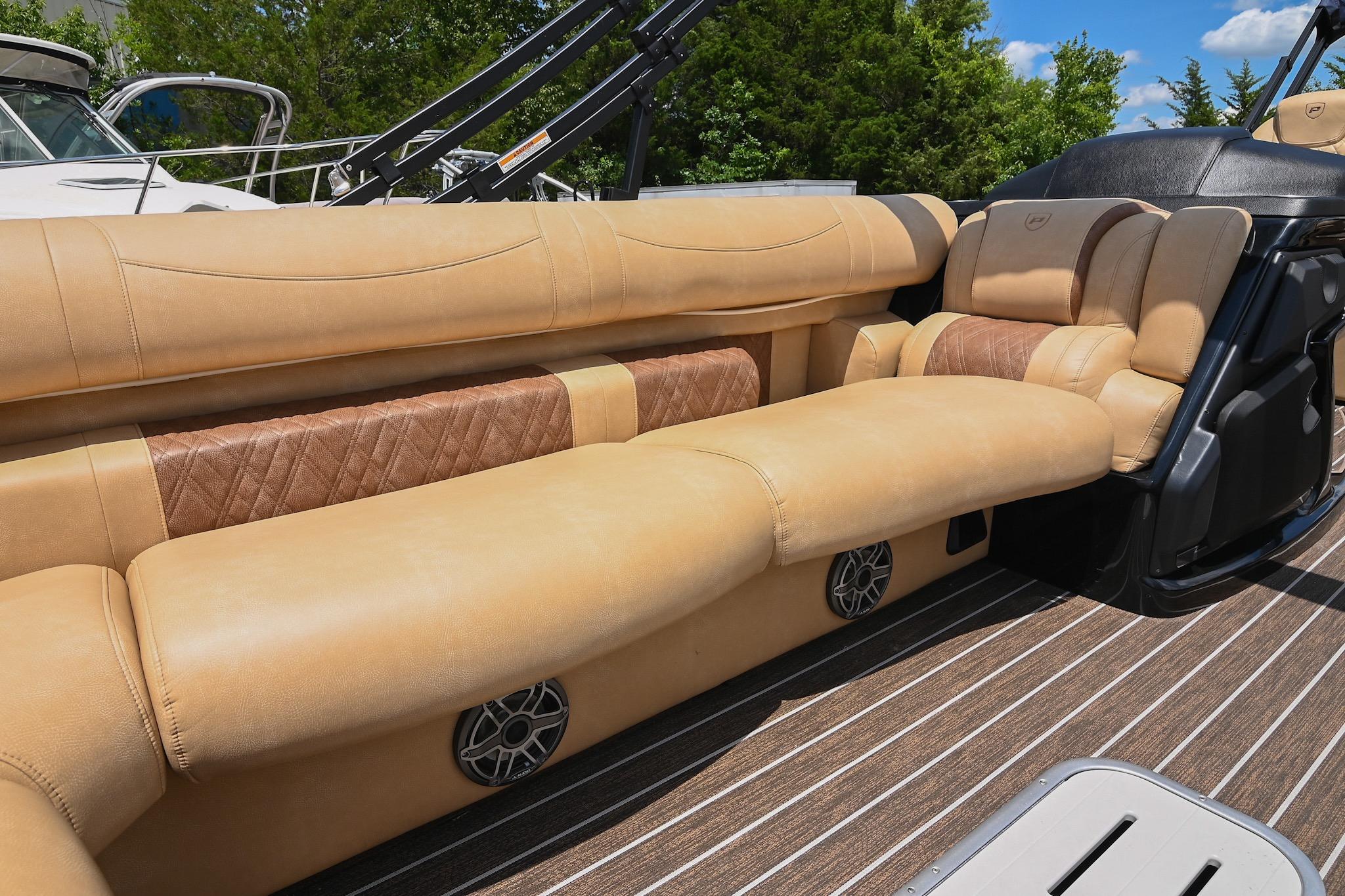 Luxurious seating on 2023 Premier 270 Intrigue RF boat with tan upholstery and sleek design.
