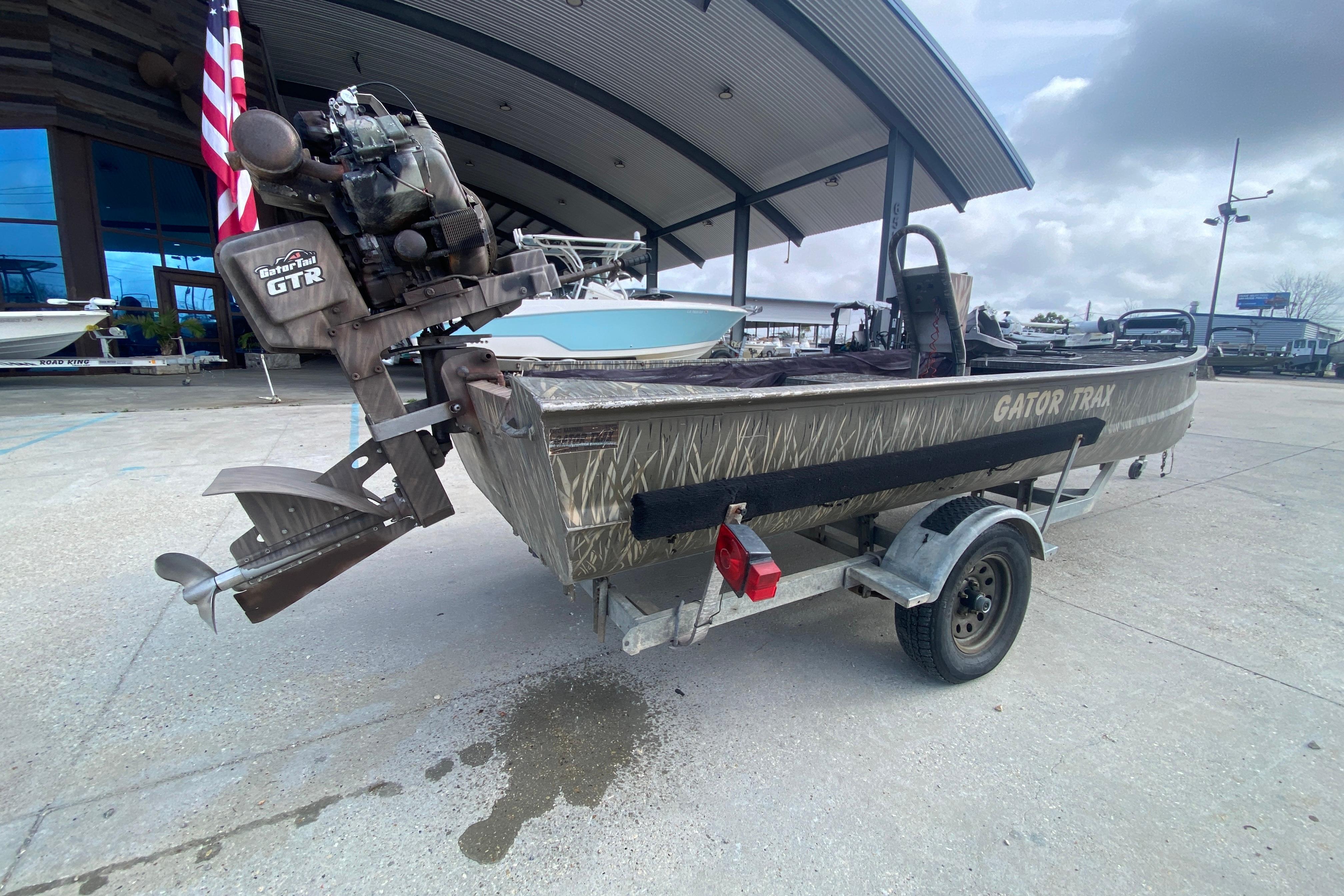 2009 Gator Trax MUD BUDDY 17 X 50 boat on trailer, outdoor setting.