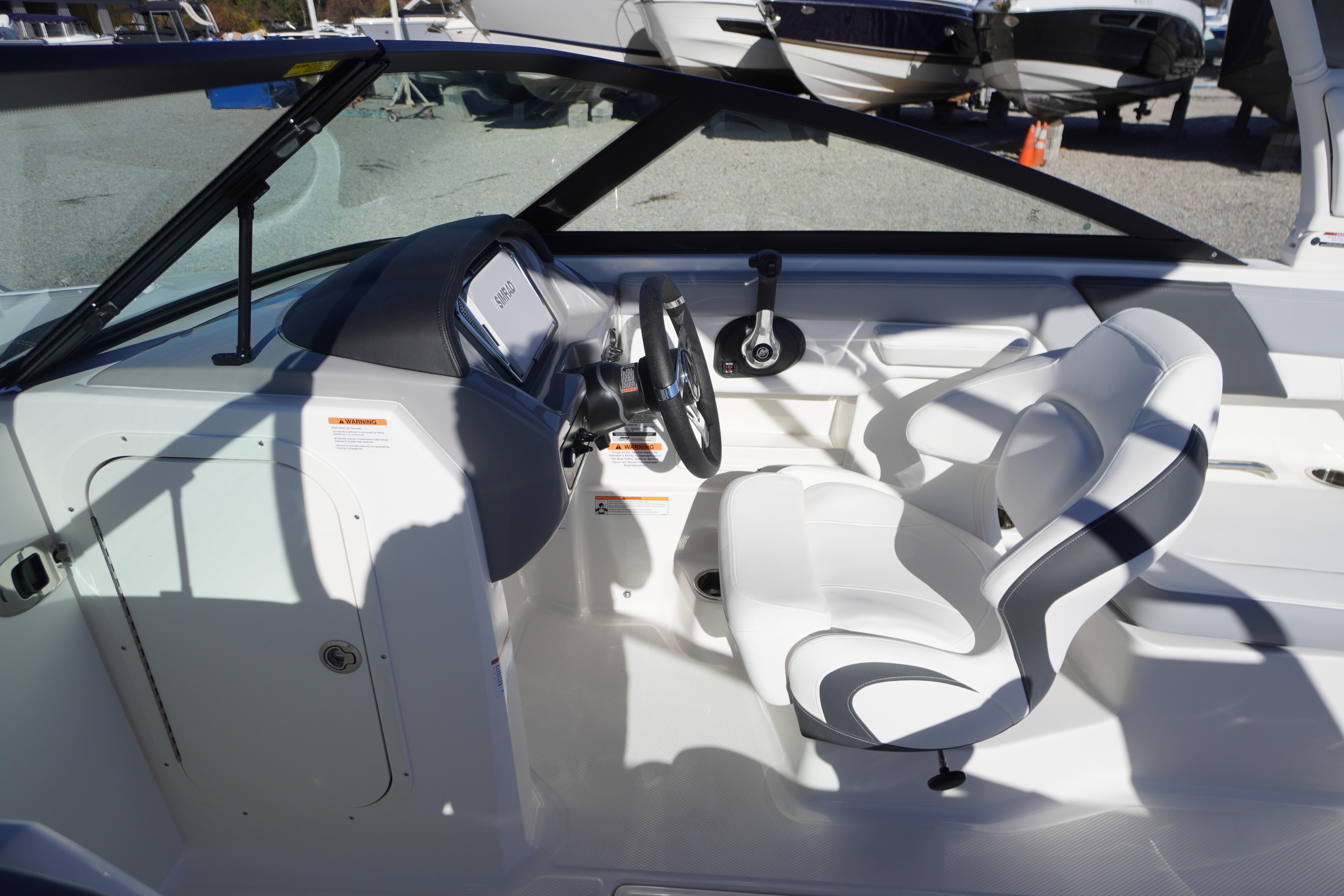 Interior of 2026 Chaparral 23 SSi boat with white seating and steering console.