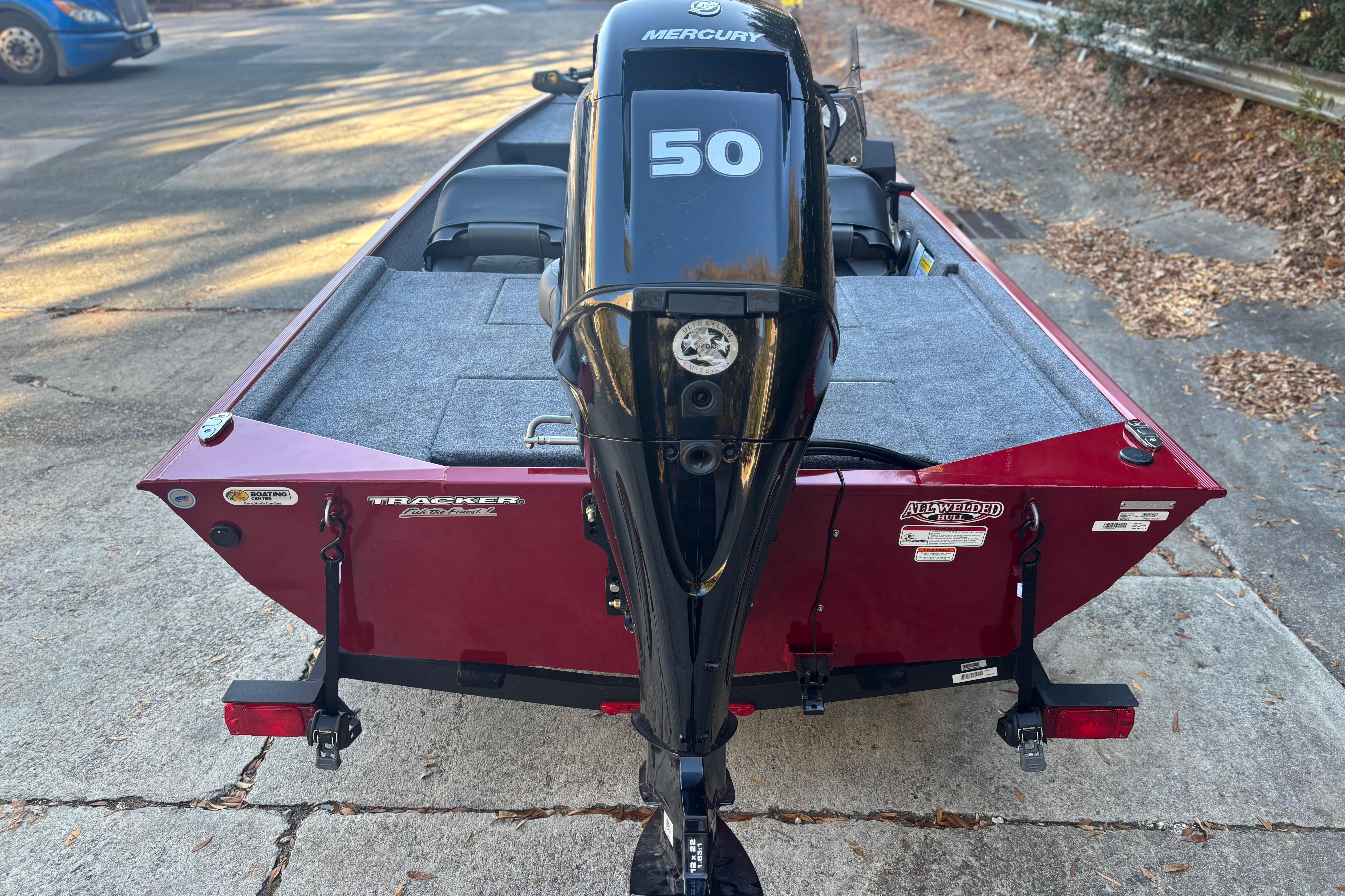 2026 Tracker Bass Tracker Classic XL boat with Mercury 50 engine, parked on pavement.