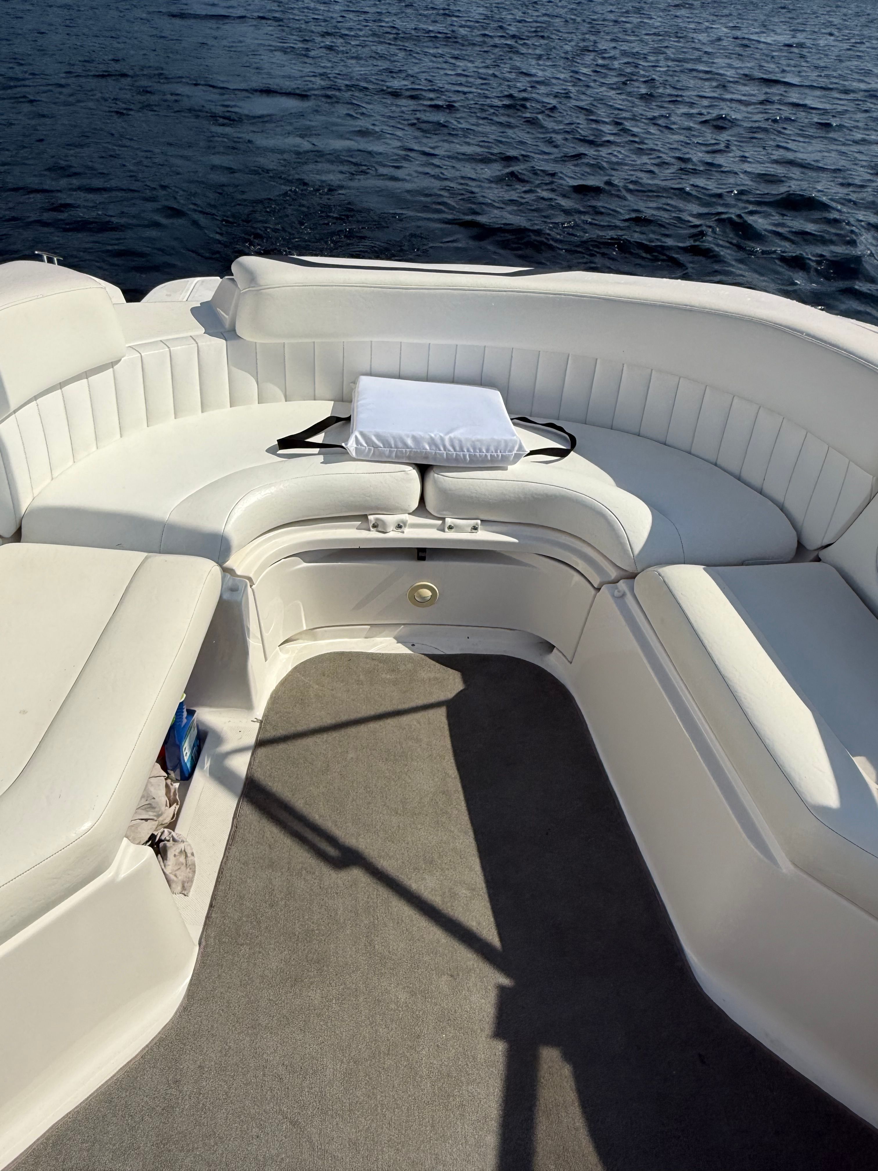 2007 Regal 2400 Bowrider interior with white seating, on calm water.
