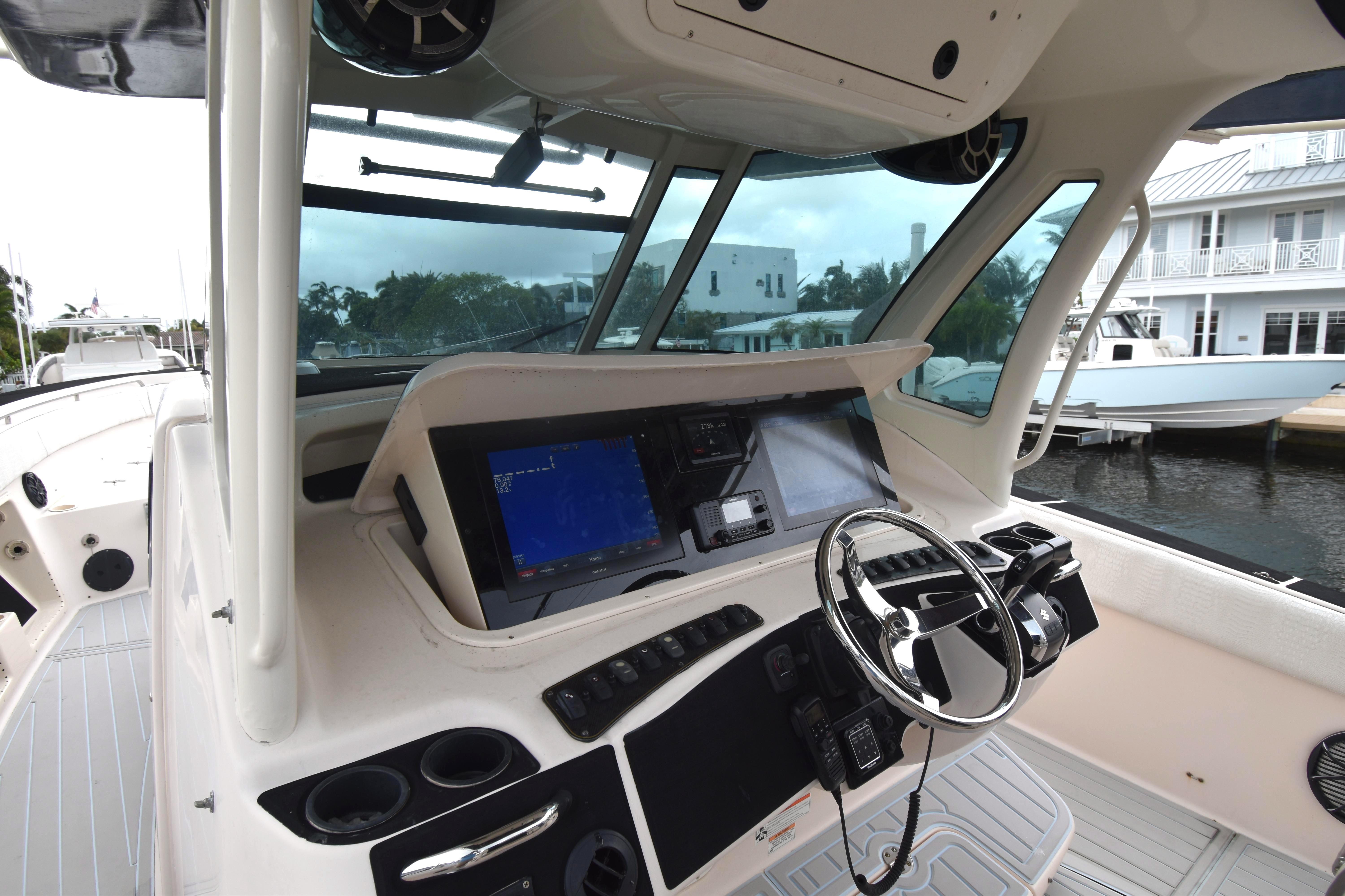 2010 Grady-White Canyon 366 boat helm with modern navigation equipment and steering wheel.