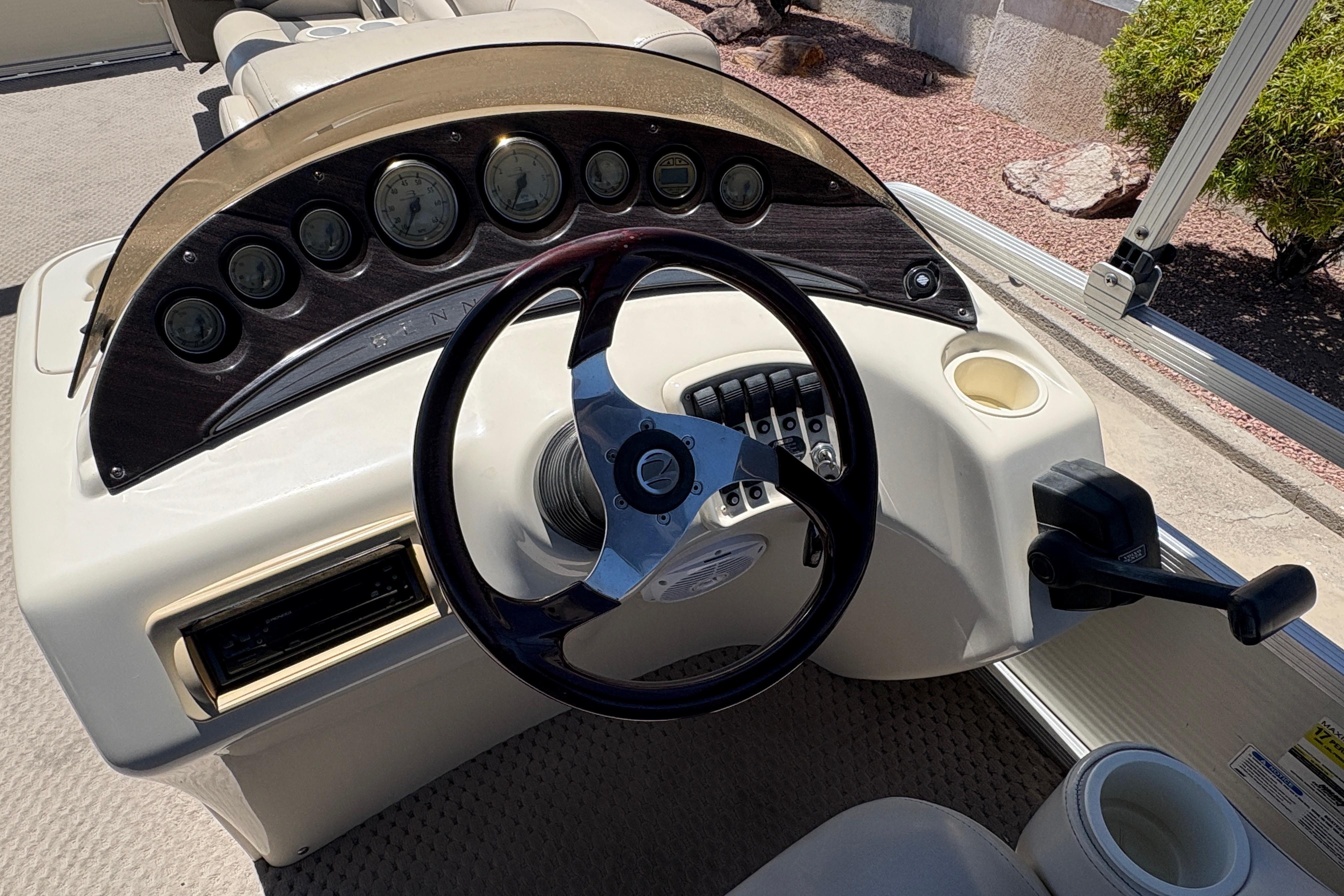 Steering console of a 2005 Bennington 2575RFS I/O boat with gauges and controls.