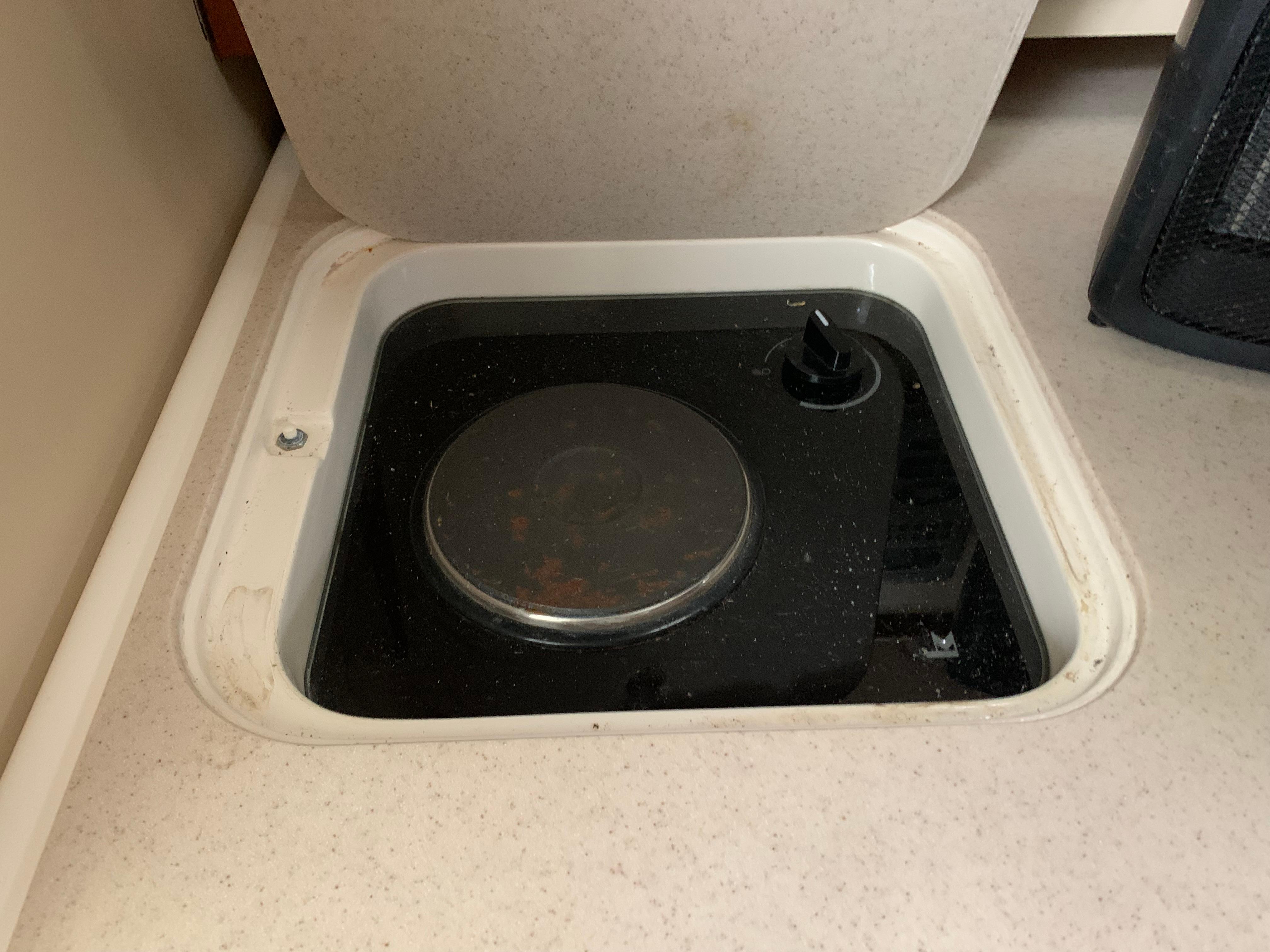 2007 Pursuit OS 335 boat stove with a single burner and control knob.