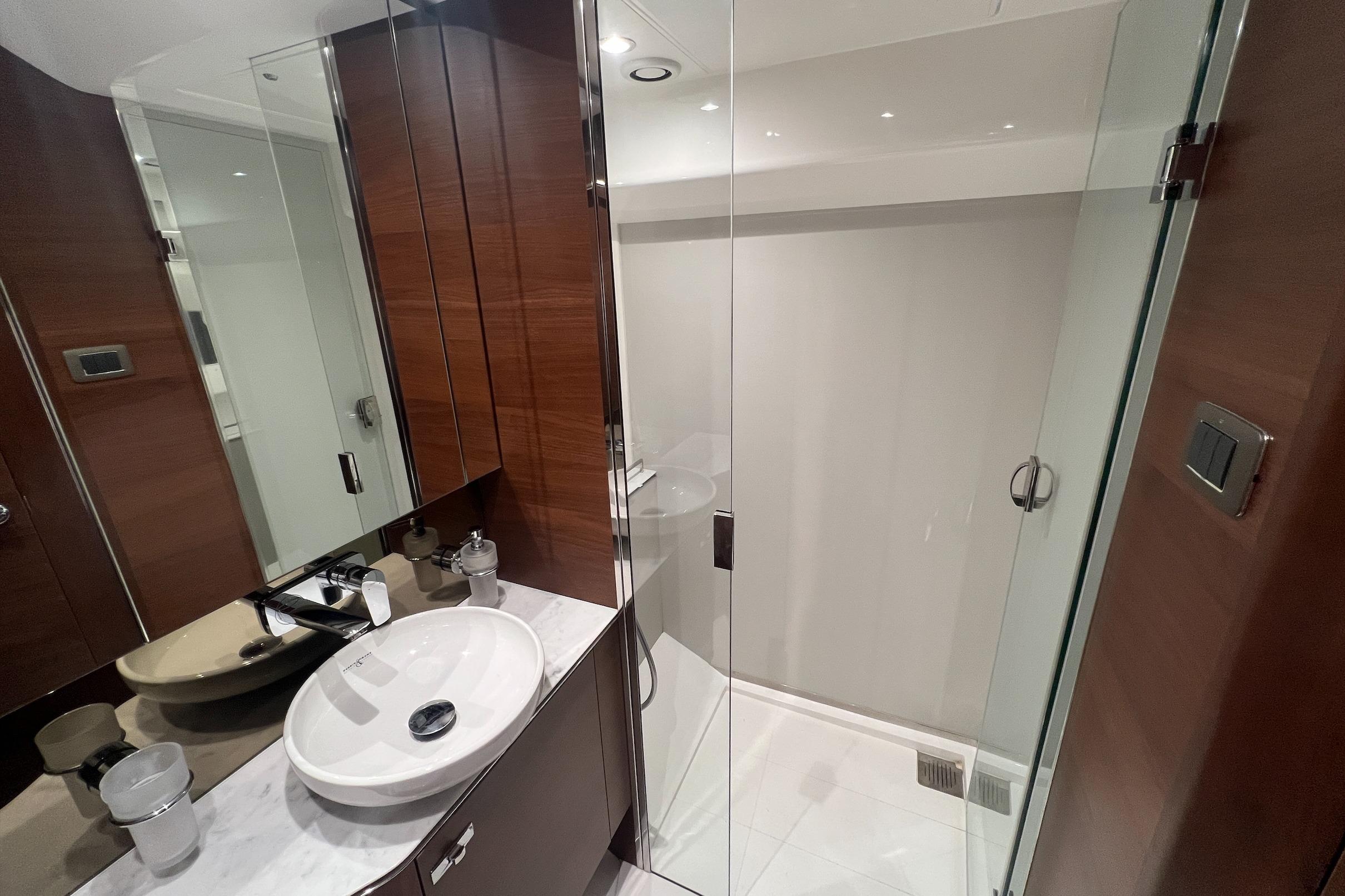Luxurious bathroom in 2019 Princess F45 yacht with modern fixtures and glass shower.
